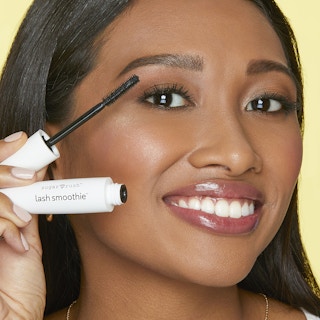woman holding up tarte mascara in front of her face
