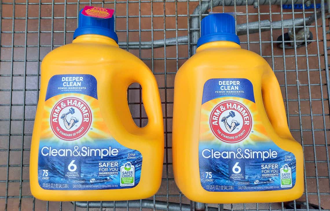 two bottles of arm & hammer clean & simple laundry detergent in walmart cart