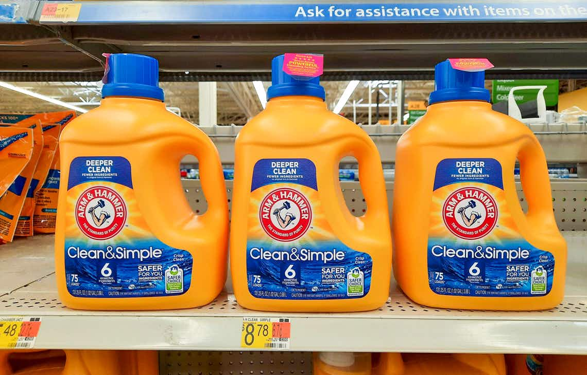 three bottles of arm & hammer clean & simple laundry detergent on walmart shelf