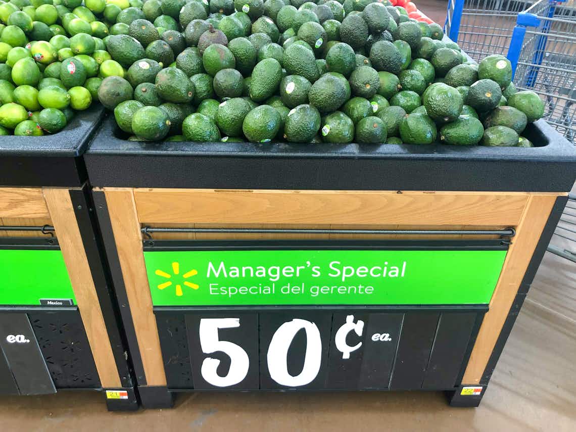 avocados on produce stand with manager special price sign