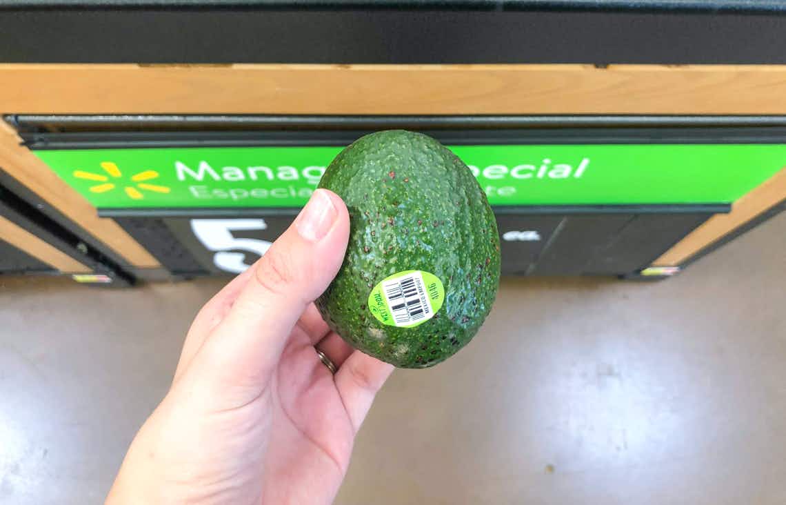 avocado being held above the floor and price sign