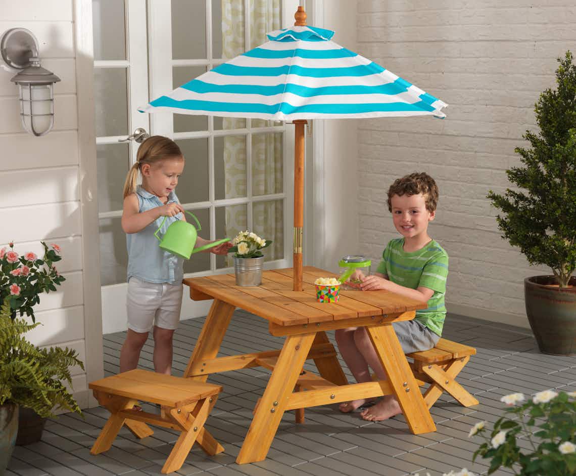 stock photo of kidkraft outdoor picnic table with kids playing 