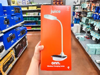 onn desk lamp with wireless charging station held in center of aisle