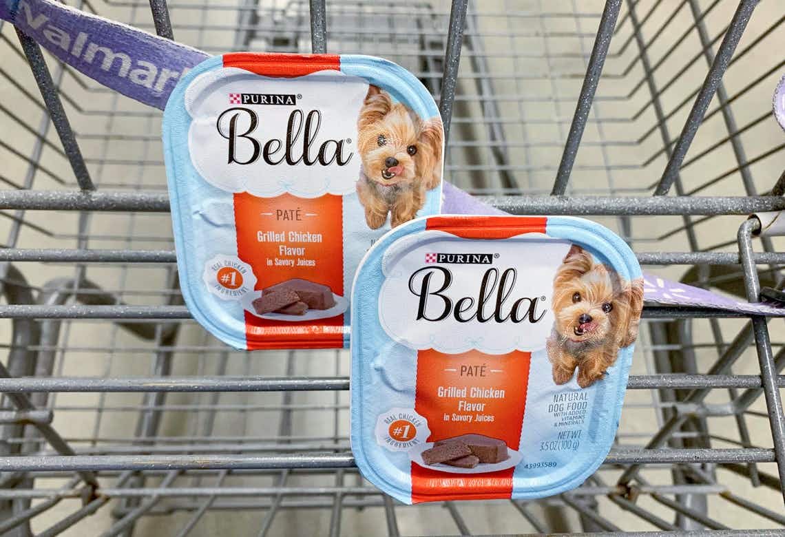 Two trays of Purina Bella wet dog food in the basket of a Walmart shopping cart.