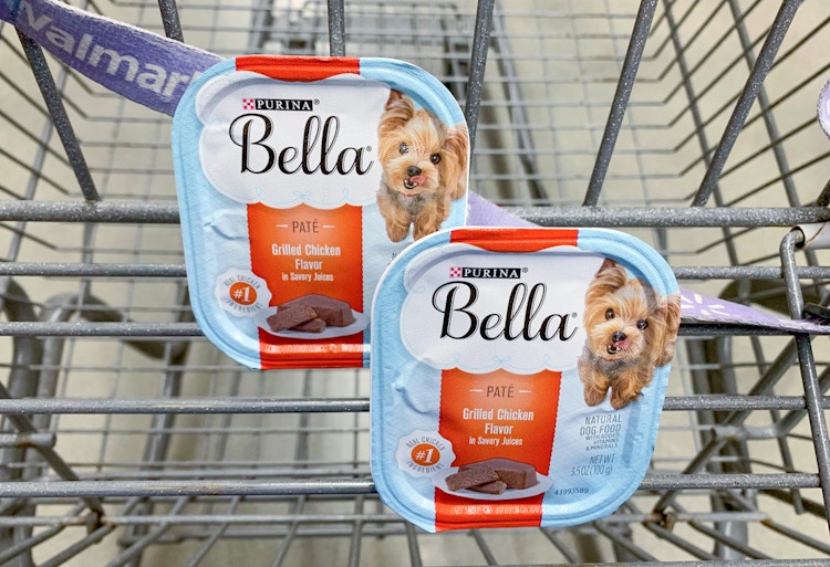 Two trays of Purina Bella wet dog food in the basket of a Walmart shopping cart.