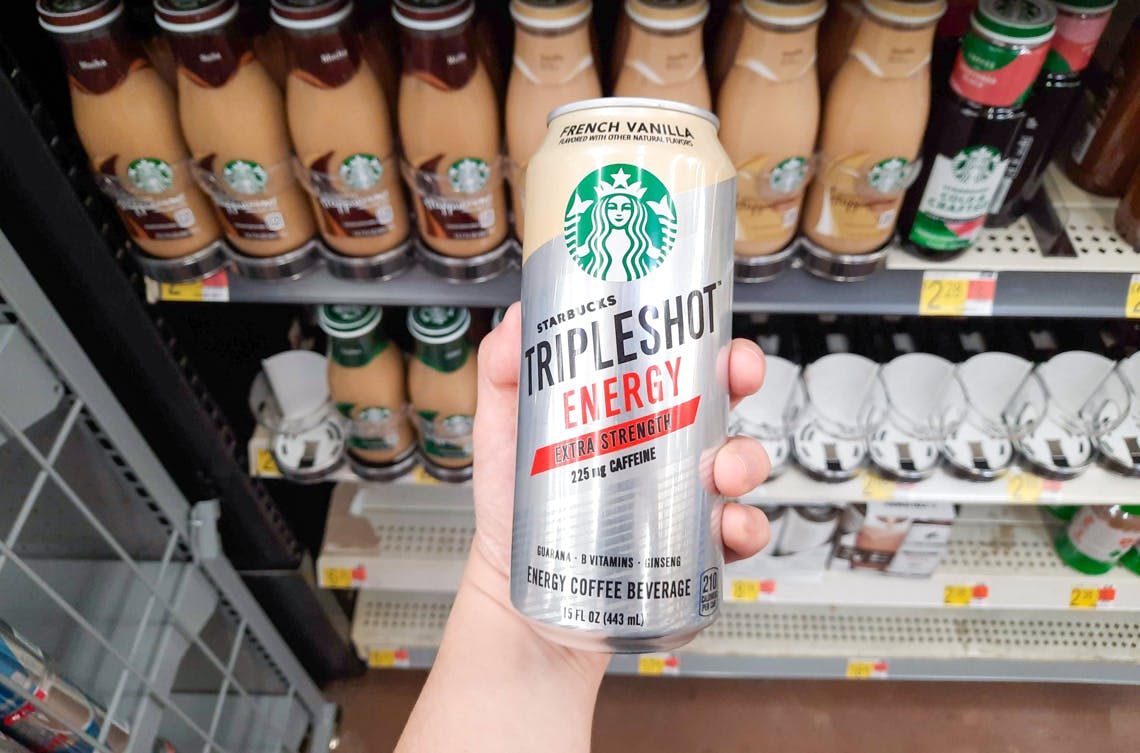 starbucks tripleshot energy drink held in front of other bottled coffees