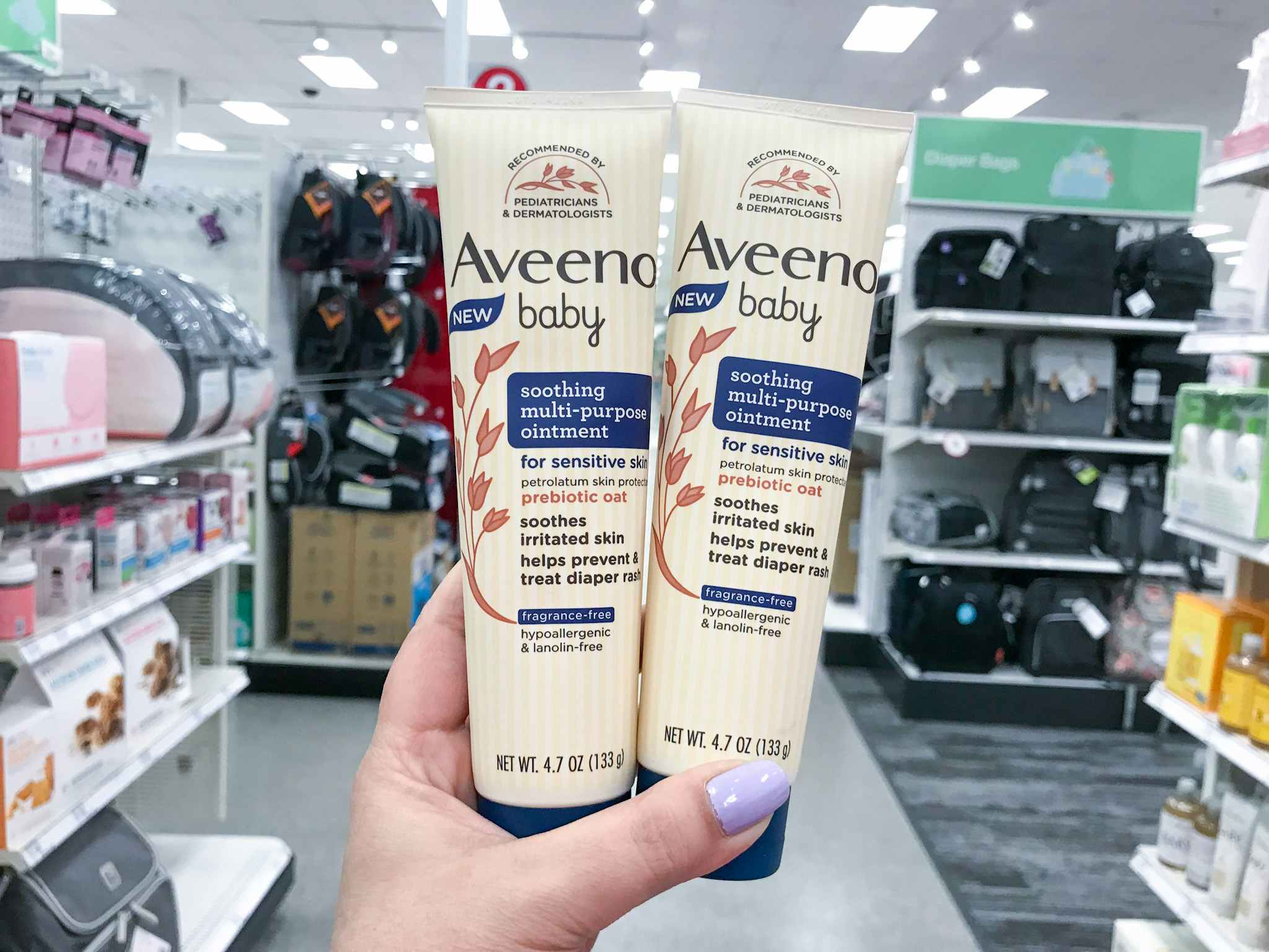 hand holding aveeno baby soothing ointment at target