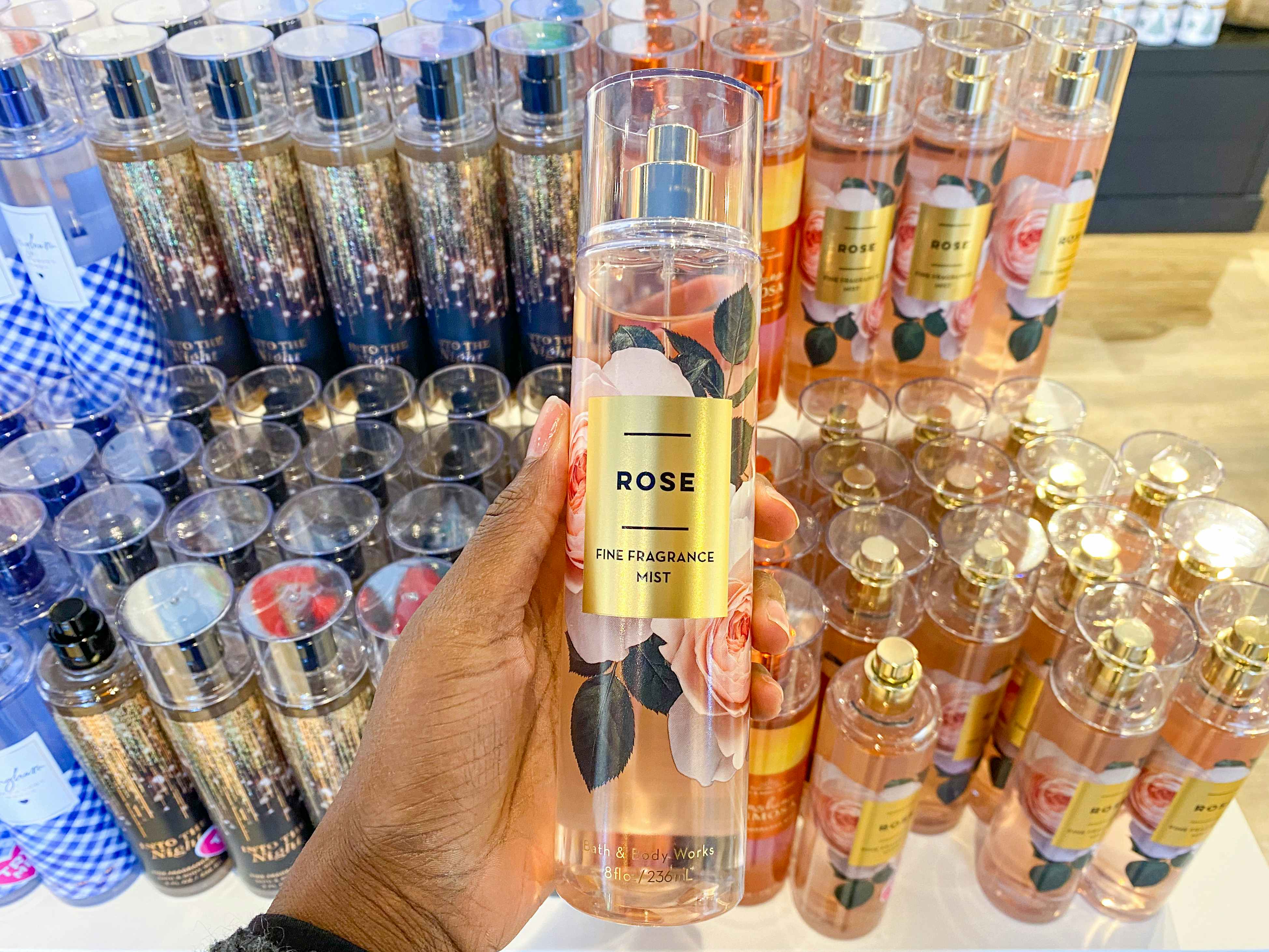 a bath and body works fine fragrance mist held in front of other mists display
