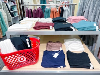 tee shirts on display shelves and in target basket