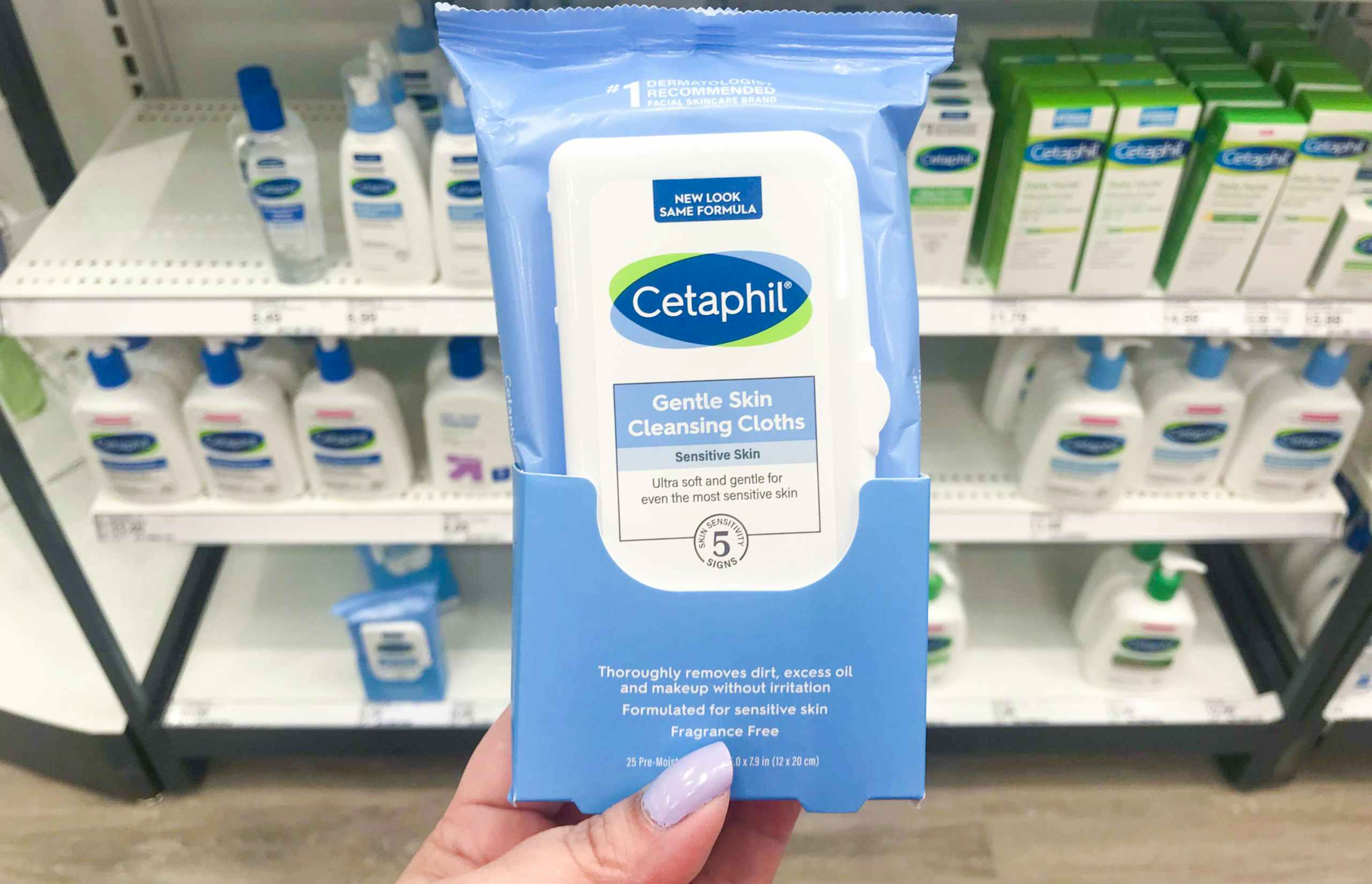 hand holding cetaphil wipes in front of Target counter