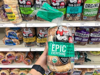hand holding dave's killer bread bagels at target