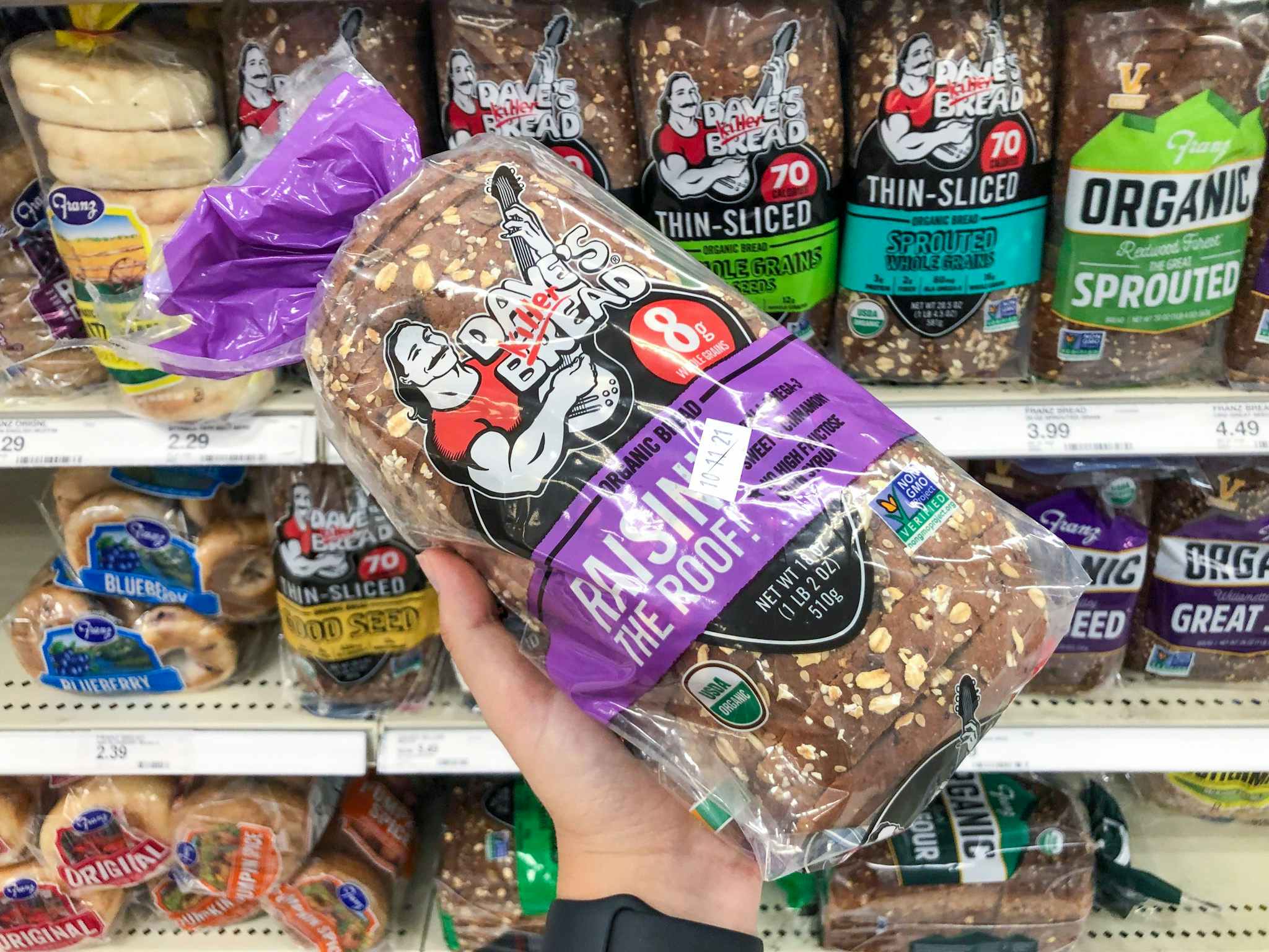 hand holding dave's killer raisin bread at target