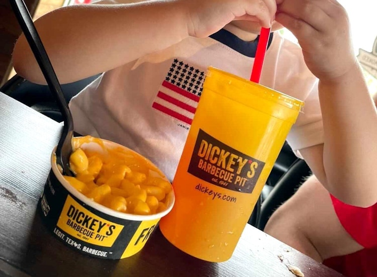 Child eating a free kids meal at Dickey's Barbecue