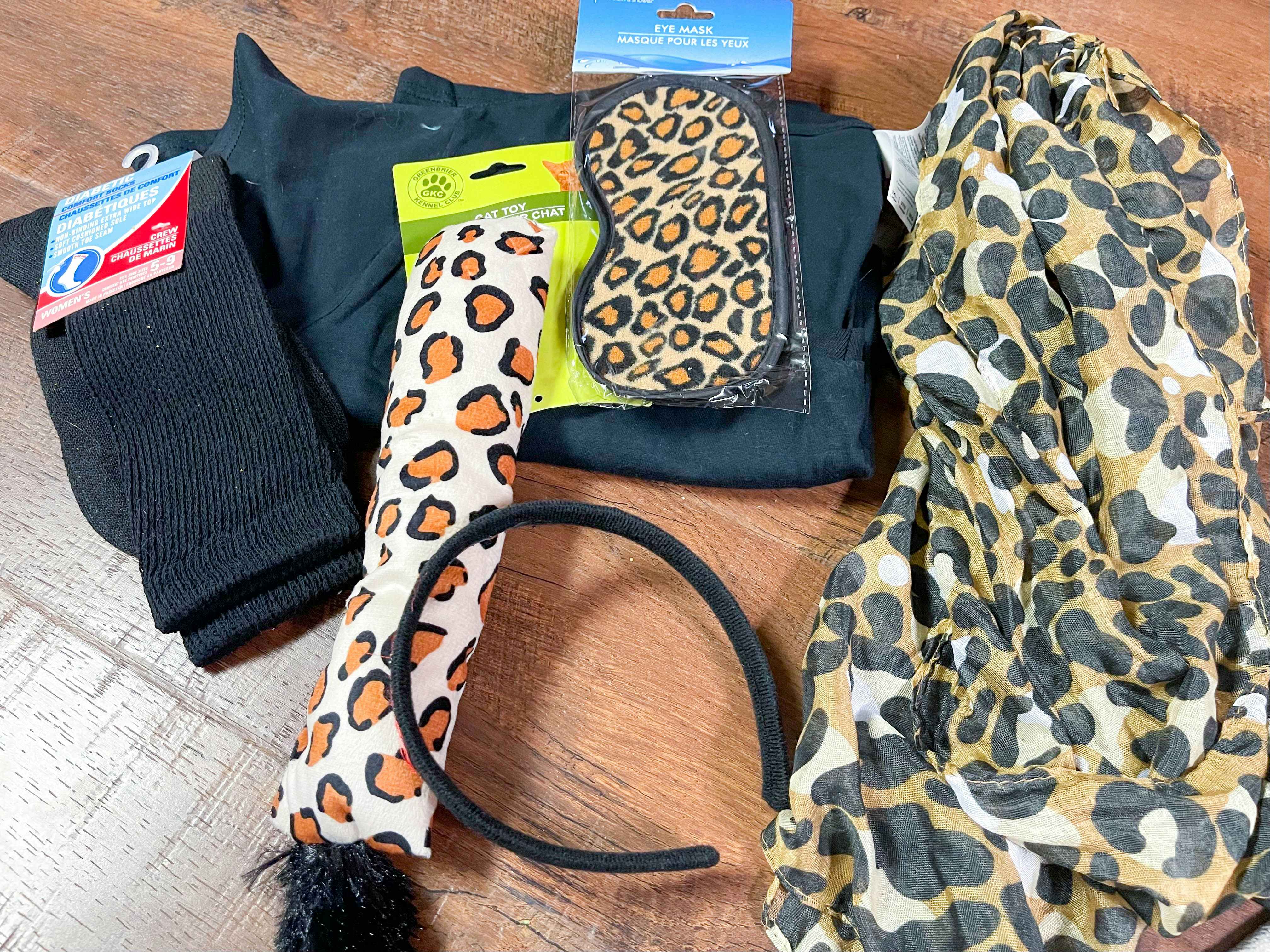 Some items from Dollar Tree that can be used to make a cat costume piled together on a wood floor.