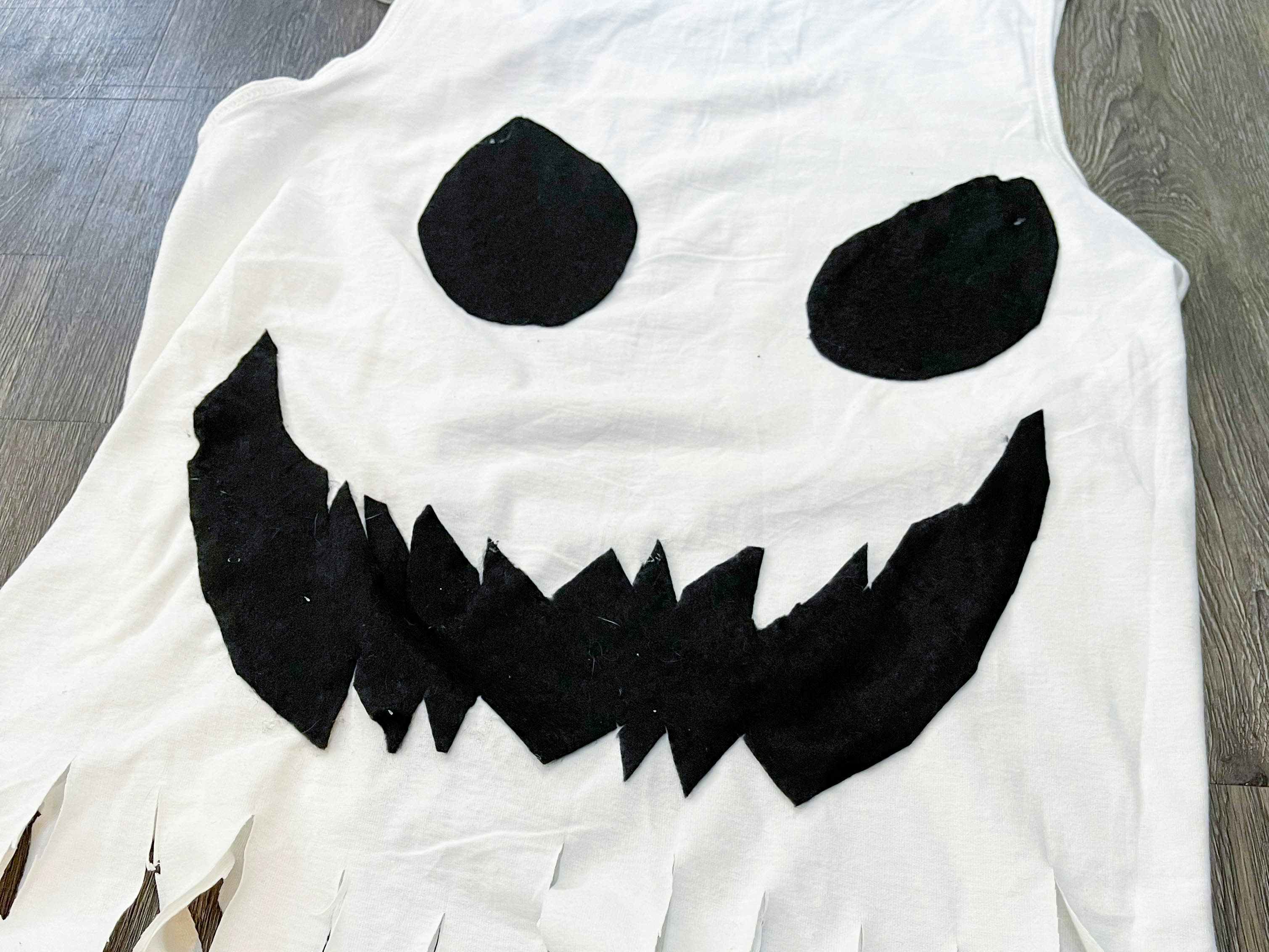 A scary face on a white shirt lying on the floor