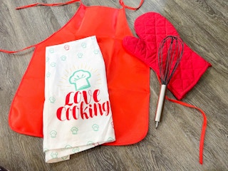 items for a baker costume laying on a wood floor