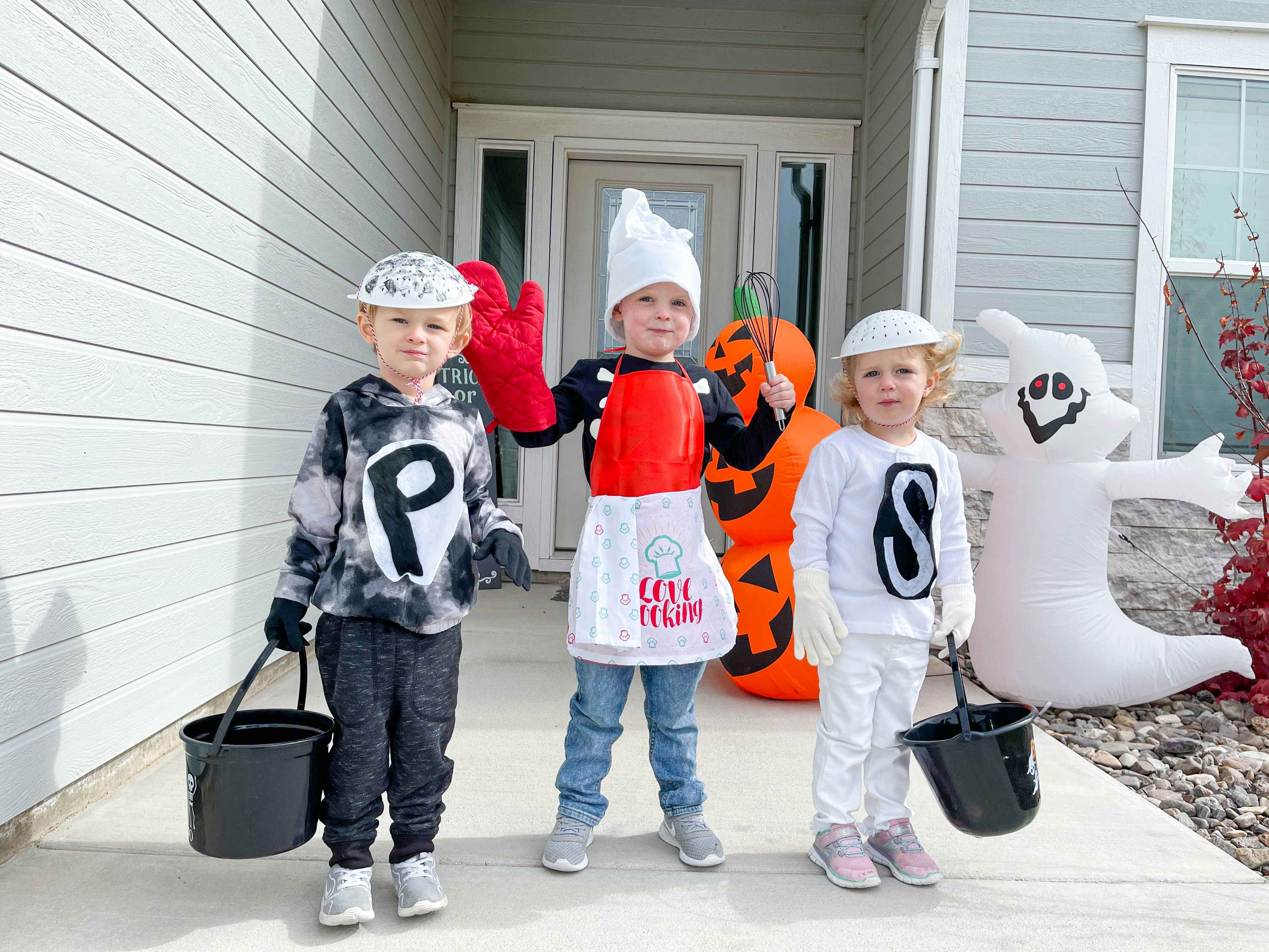 kids in costumes in front of door