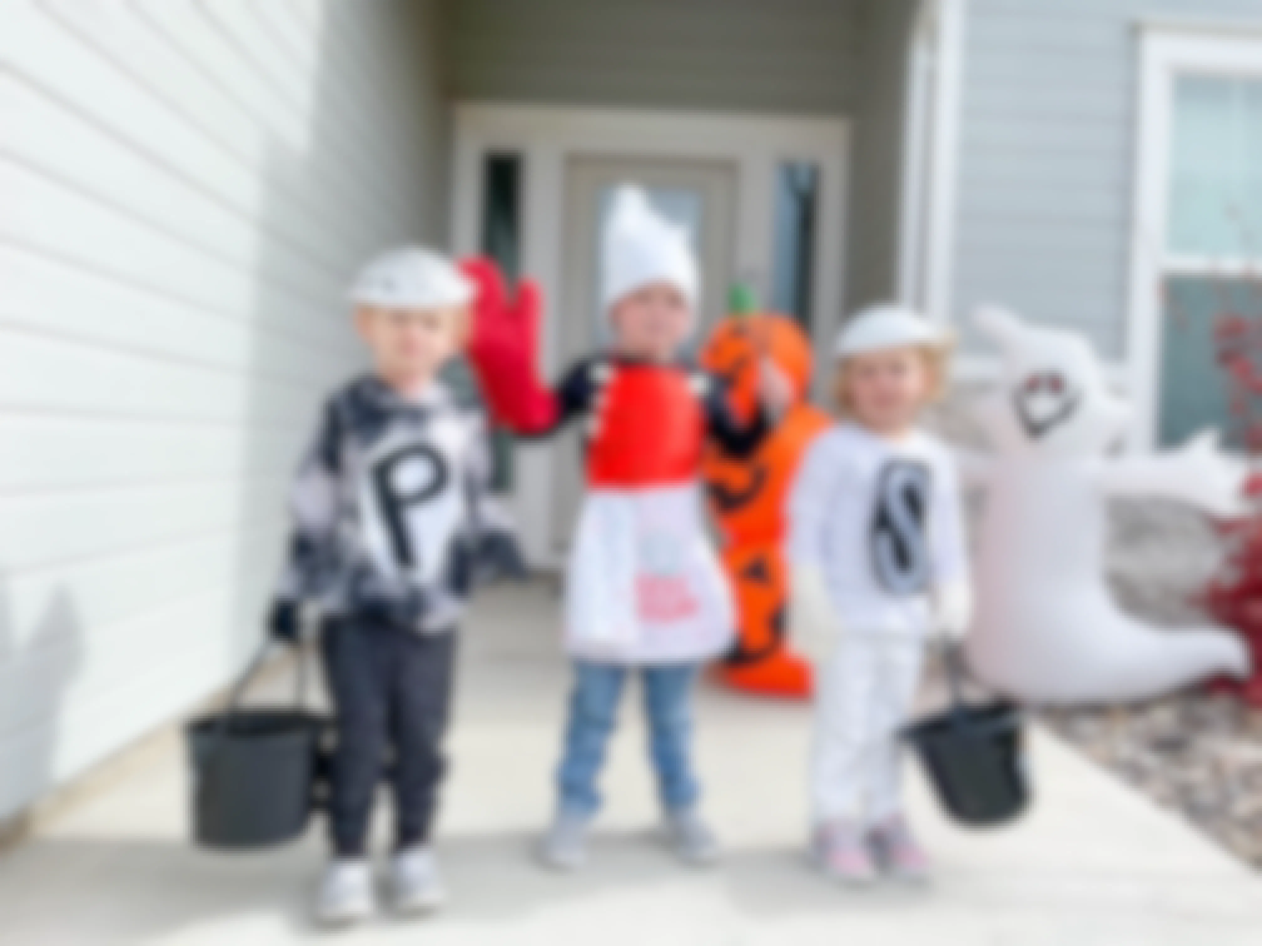 kids in costumes in front of door