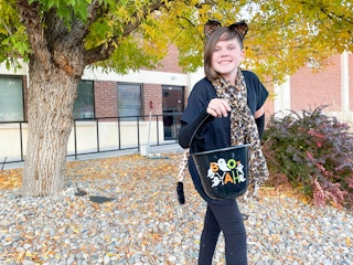 a young girl dressed in a dollar tree cheetah costume