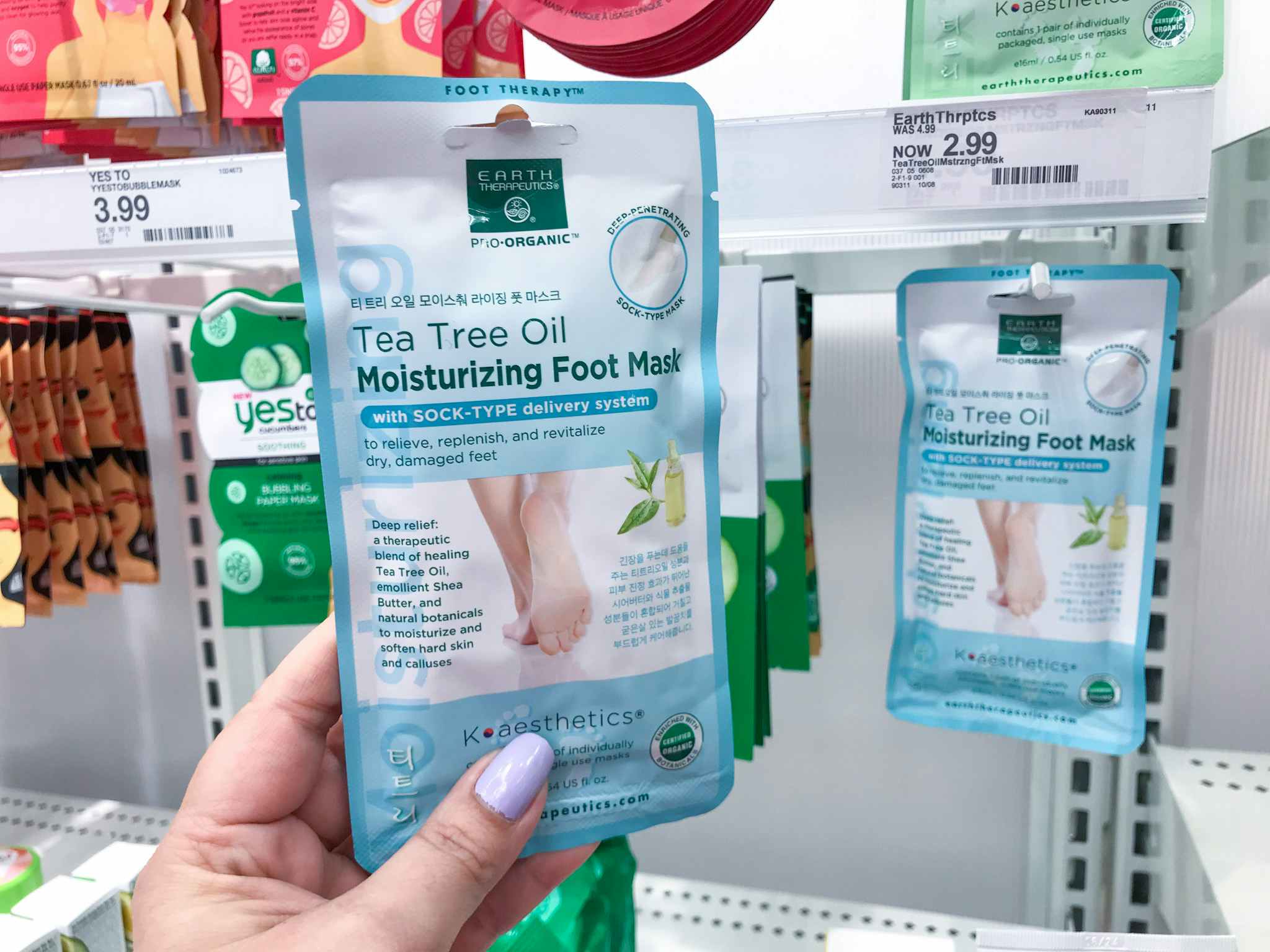 hand holding earth therapeutics foot masks at target
