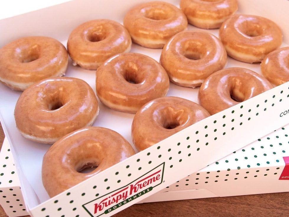 A box of a dozen Krispy Kreme doughnuts.