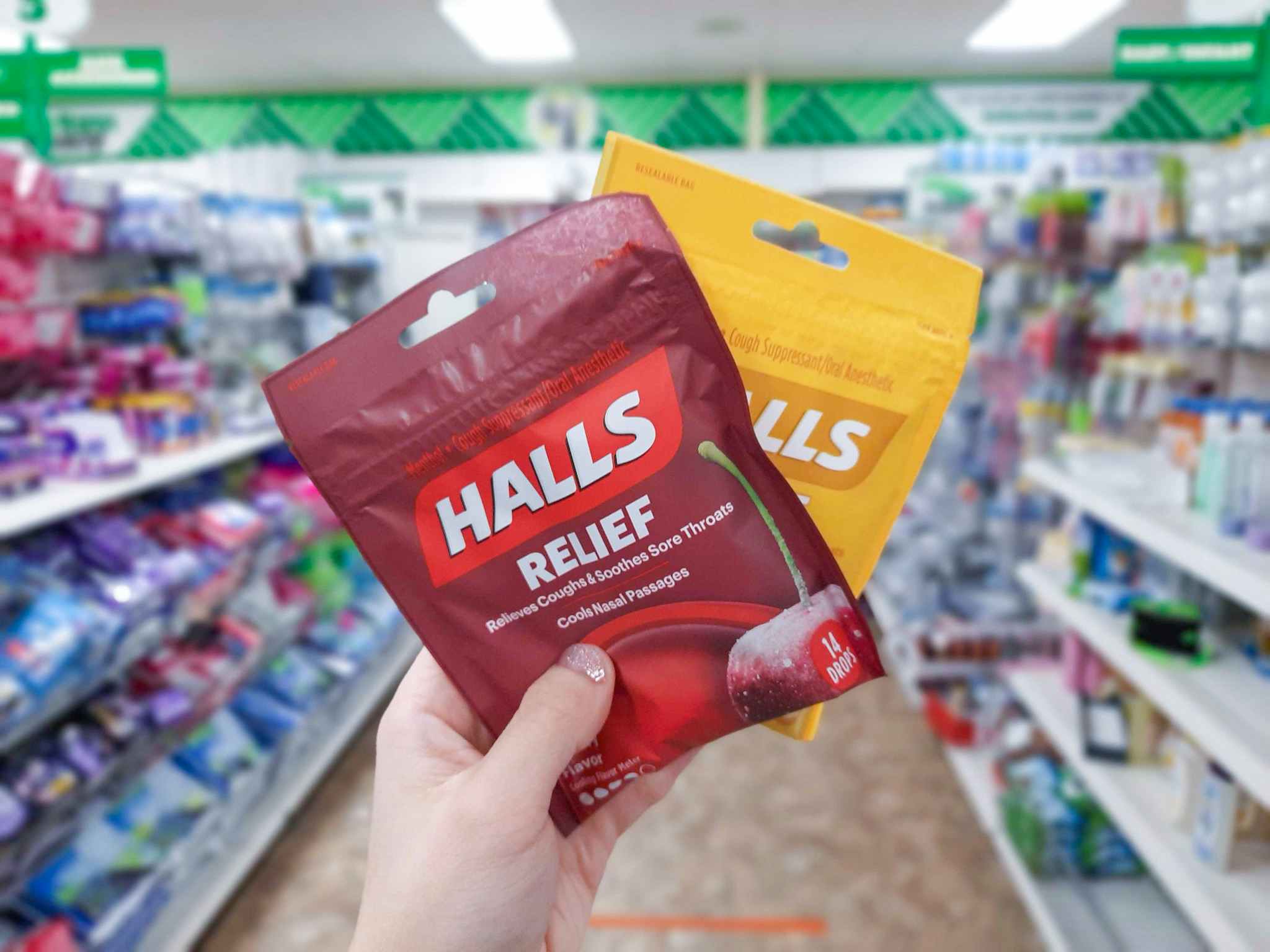 hand holding halls cough drops at dollar tree