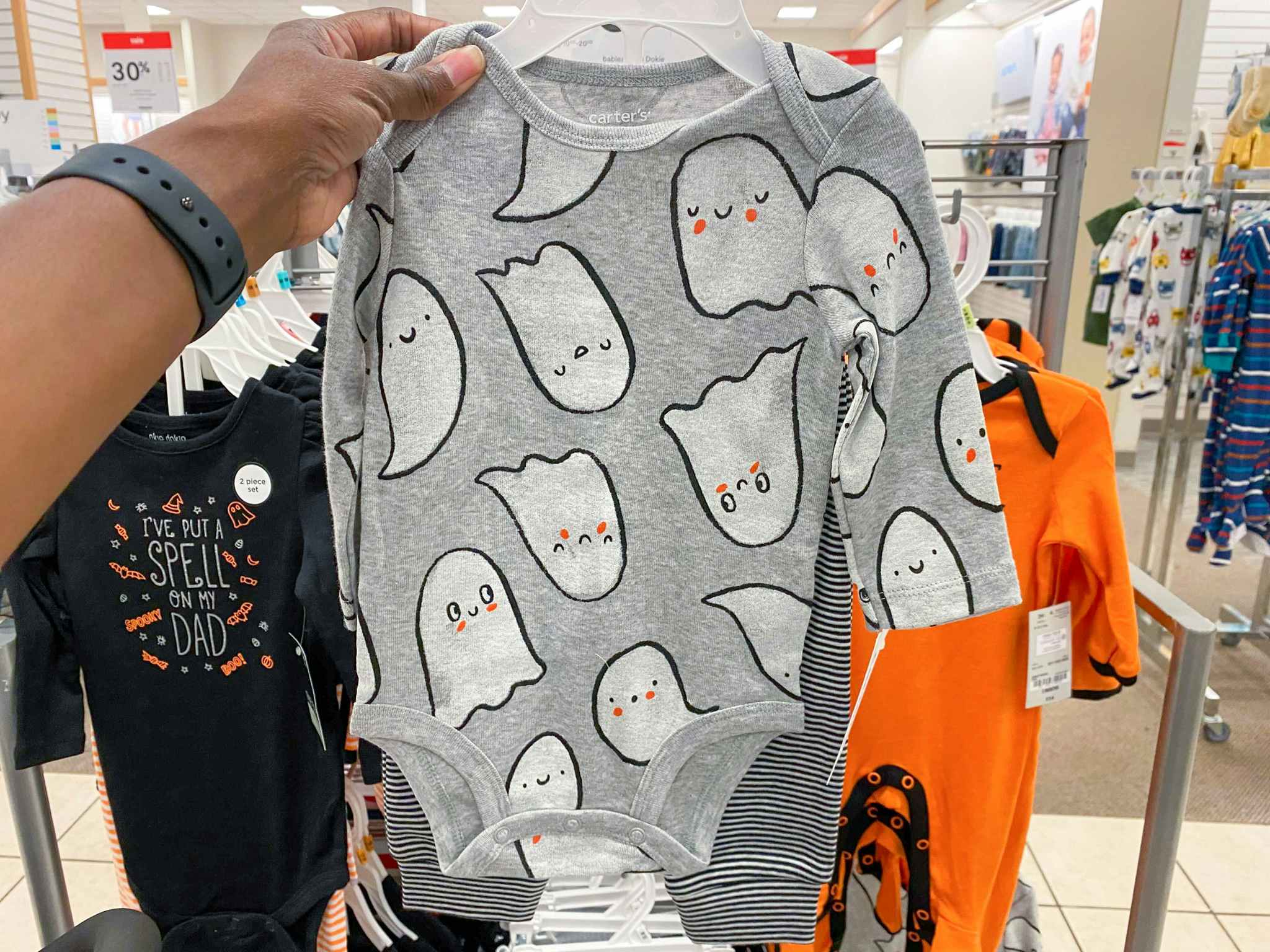 hand holding carters halloween outfit set