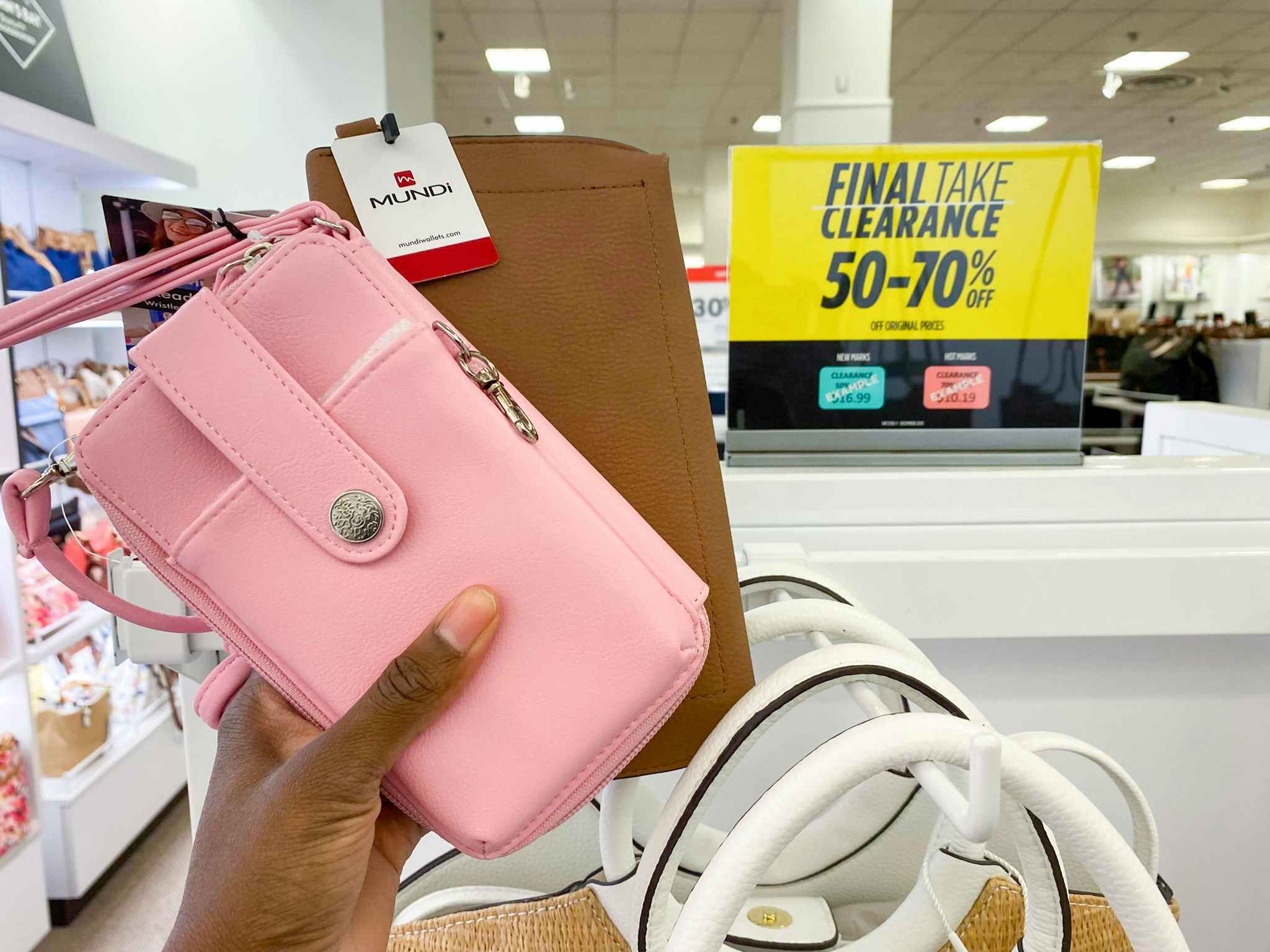 hand holding wallets in clearance section