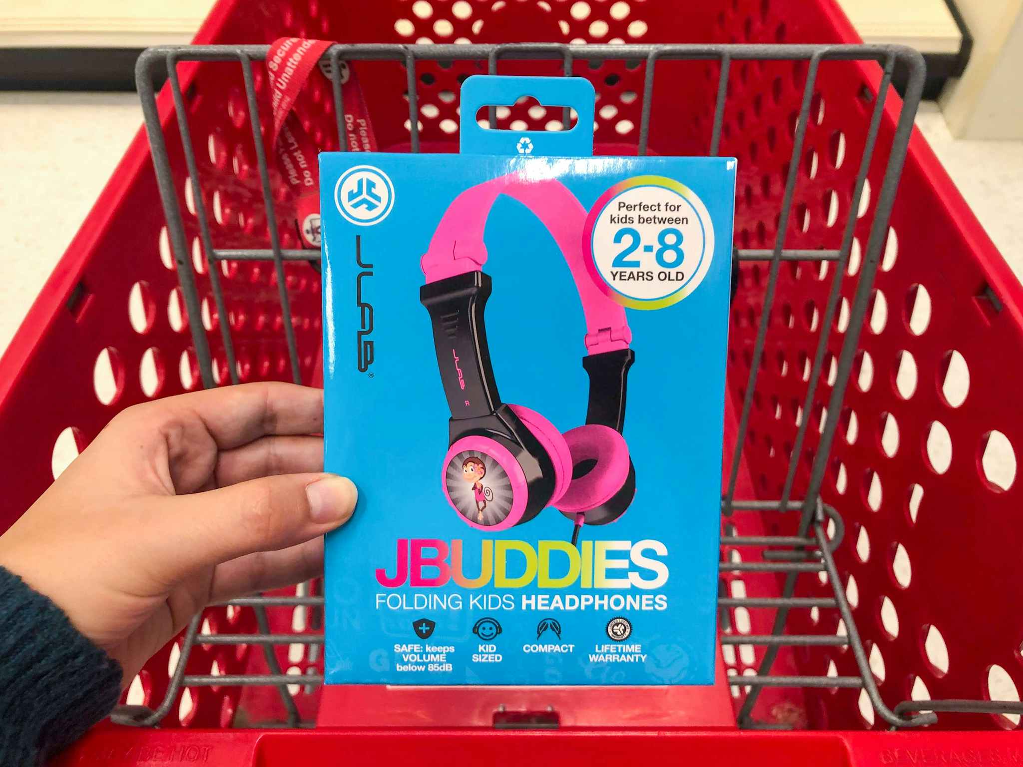 hand holding pink jlab jbuddies kids headphones at Target