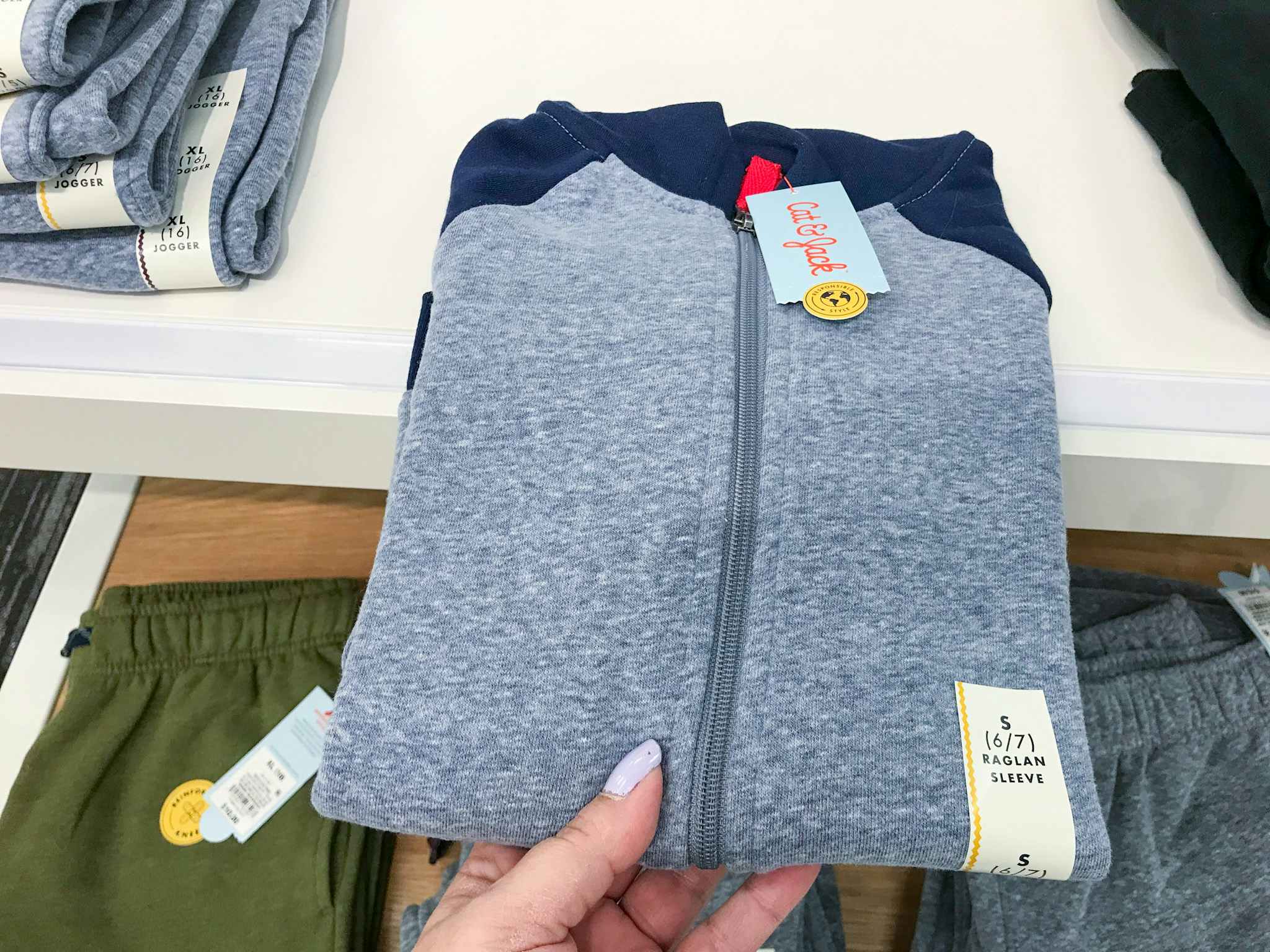 hand grabbing a cat & jack boys' fleece sweatshirt at target