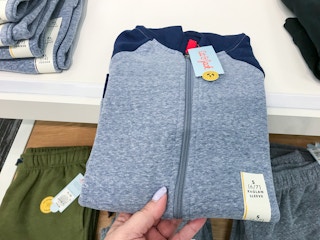 hand grabbing a cat & jack boys' fleece sweatshirt at target