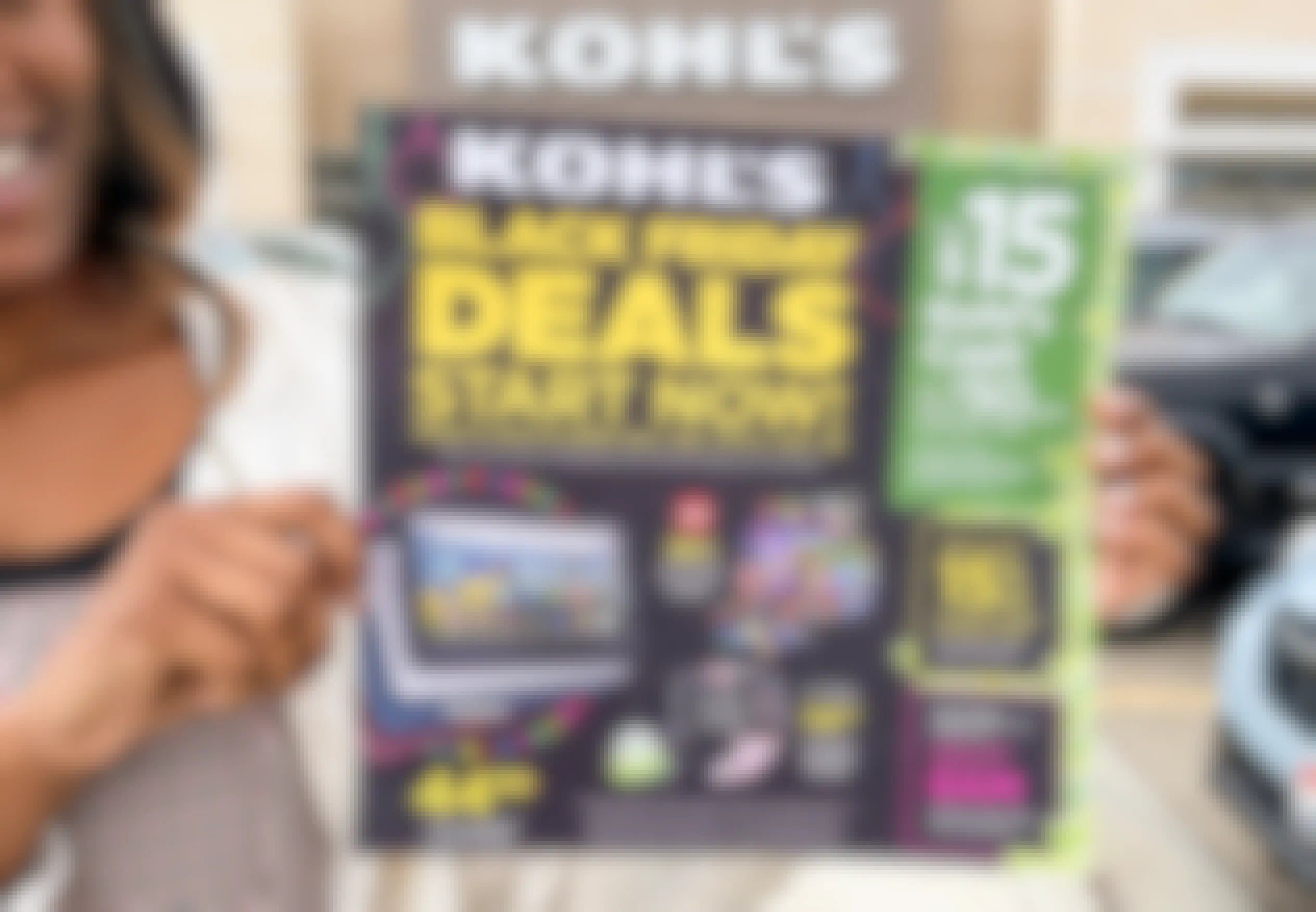 A woman holding a Kohl's Black Friday ad in front of Kohl's