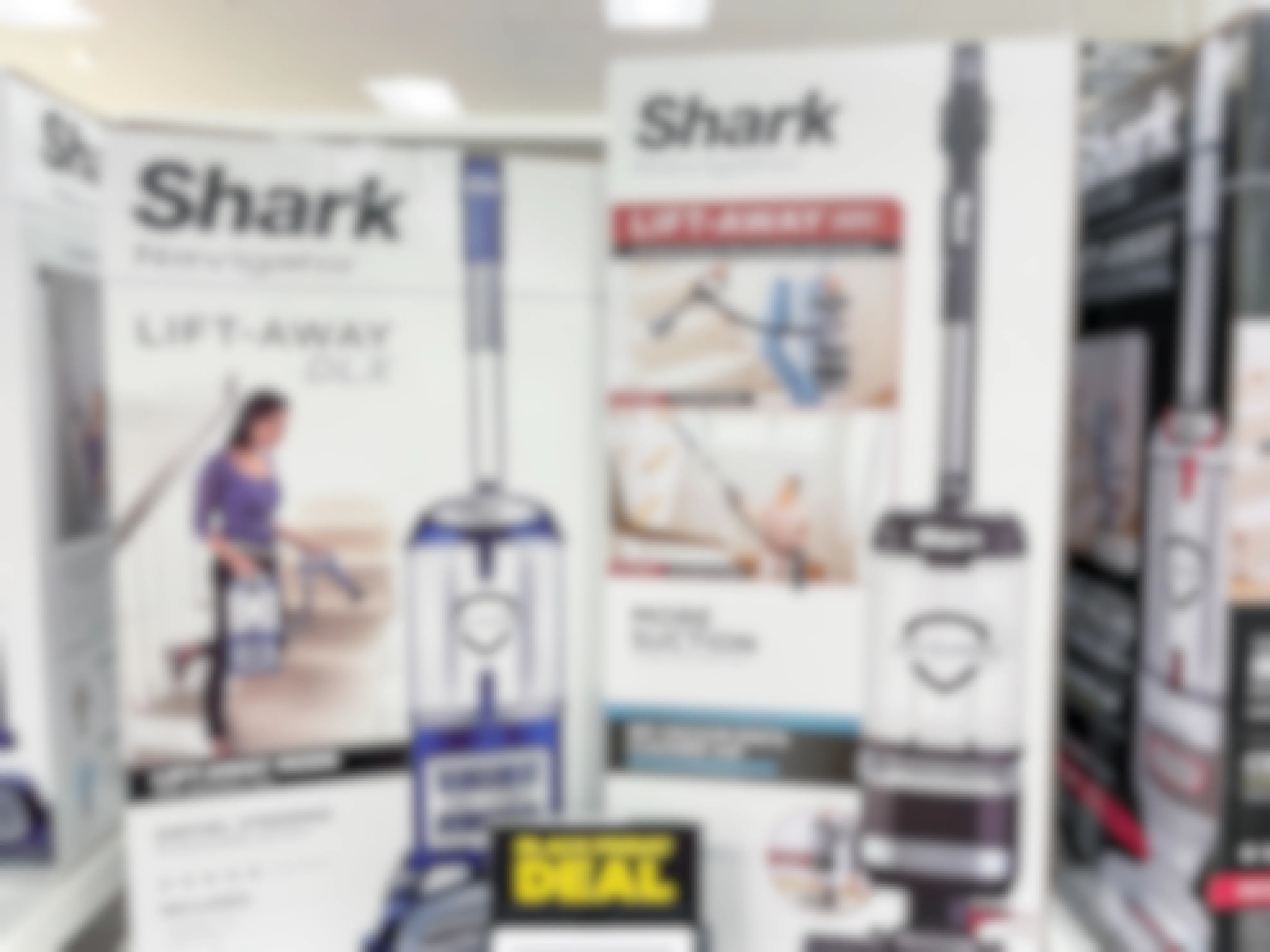 Two Shark vacuums in boxes on a shelf at Kohl's with a sign that reads, "Black Friday Deal