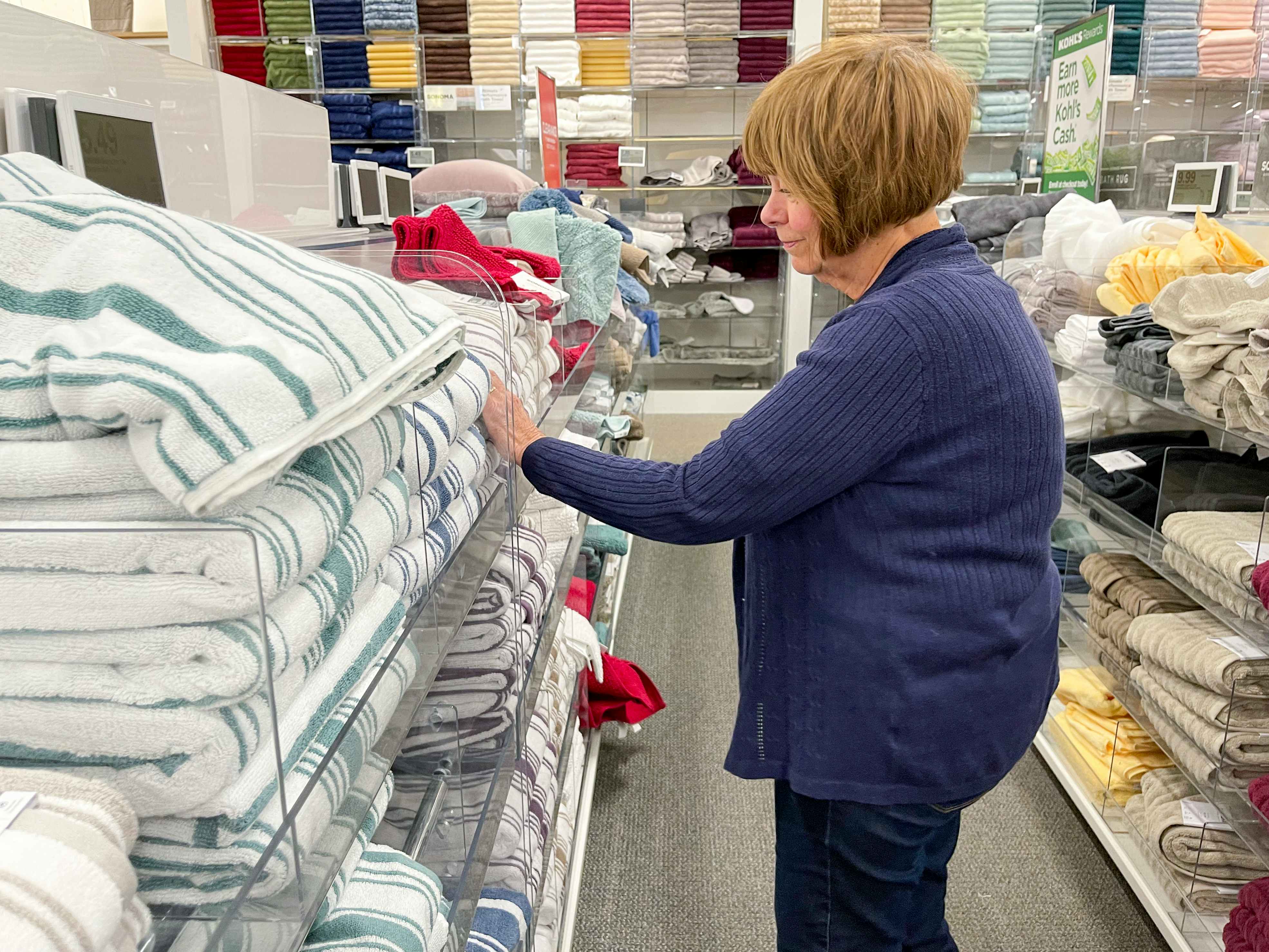 A woman shopping for towels at Kohl's