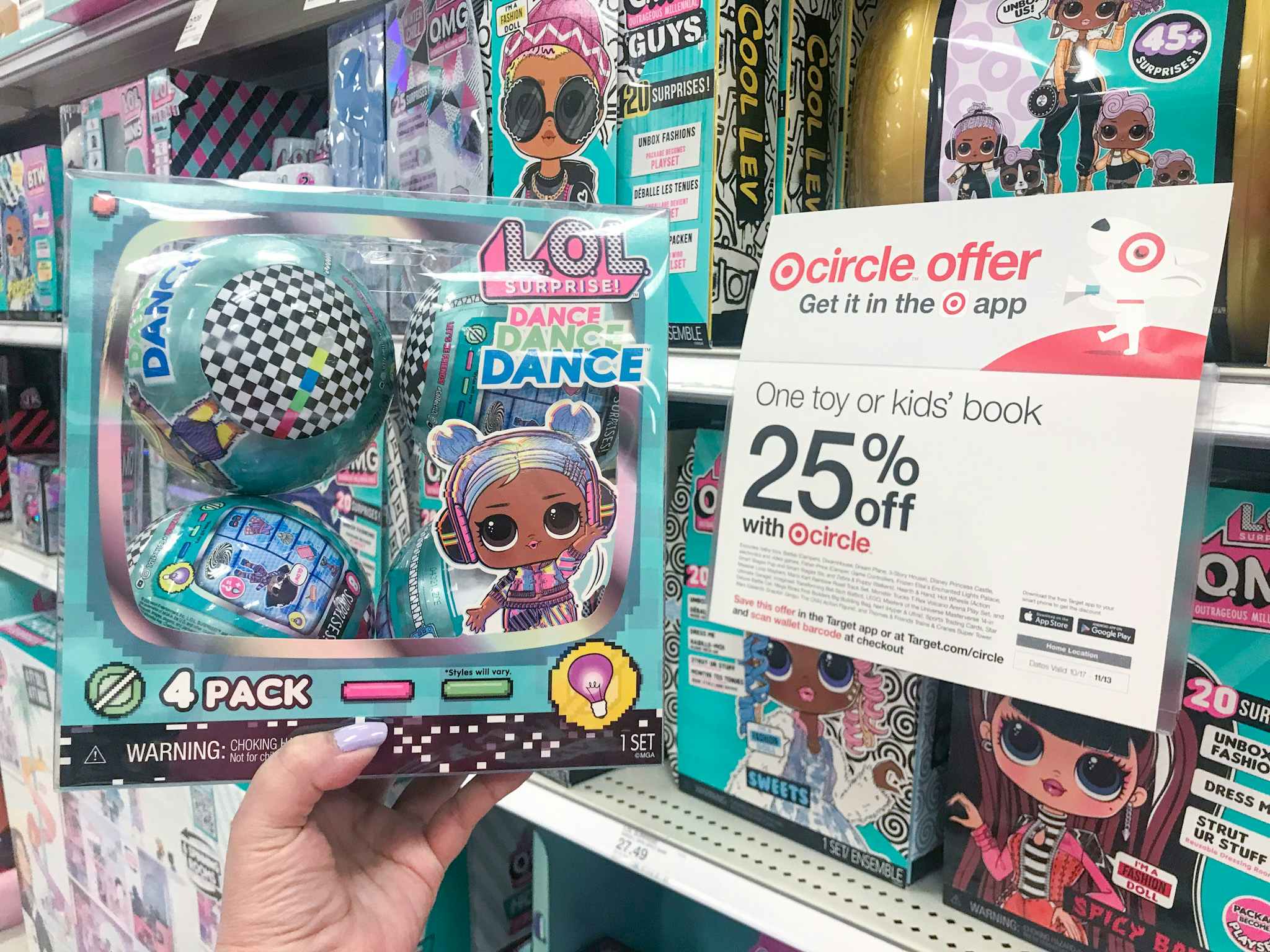 hand holding a 4-pack of lol surprise dance dance dance dolls at target