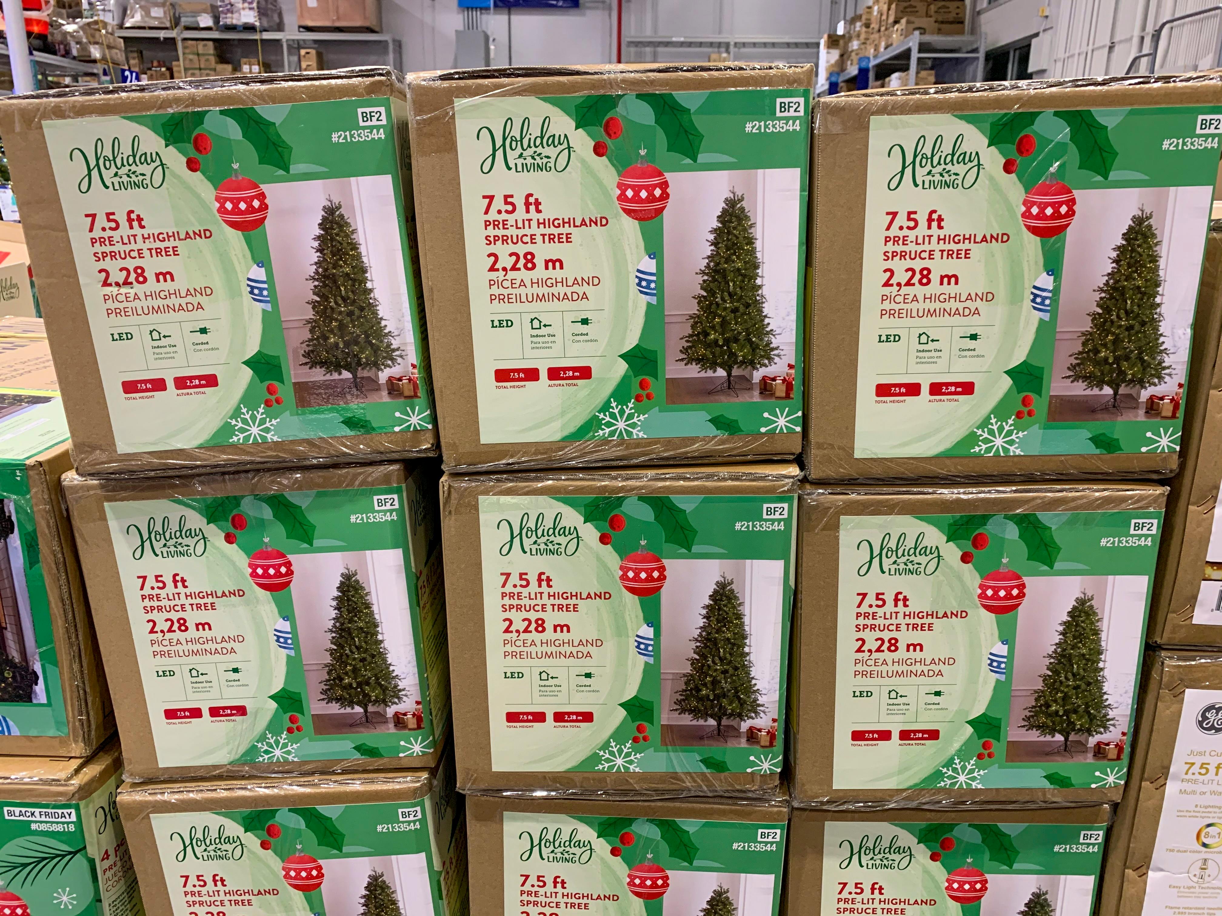 Holiday Living artificial Christmas tree boxes stacked at Lowe's during their Black Friday event.