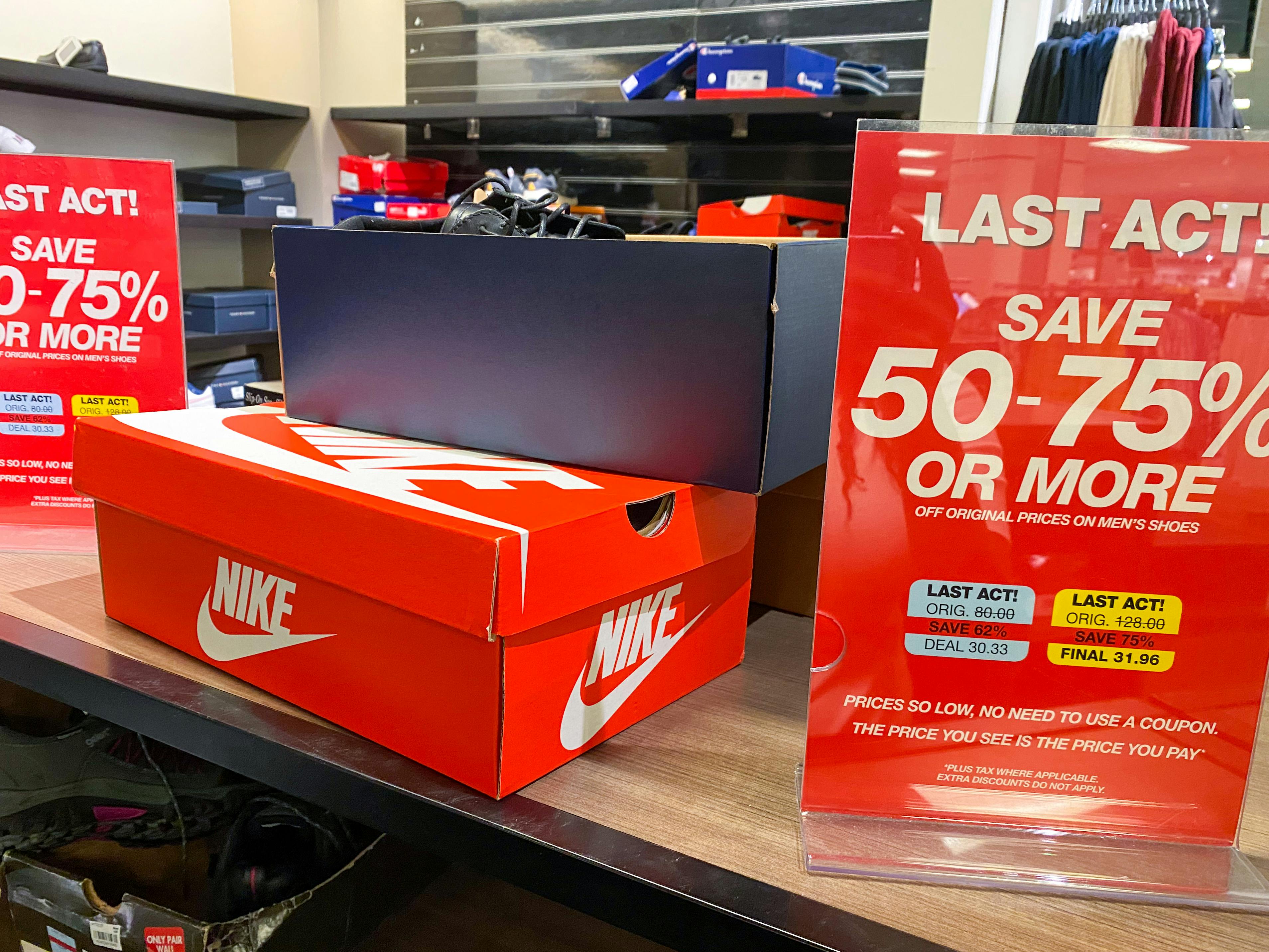 Macy's Last Act clearance signage next to Nike shoes