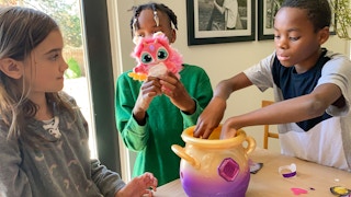 Three children playing with the Magic Mixies Magical Misting Cauldron.