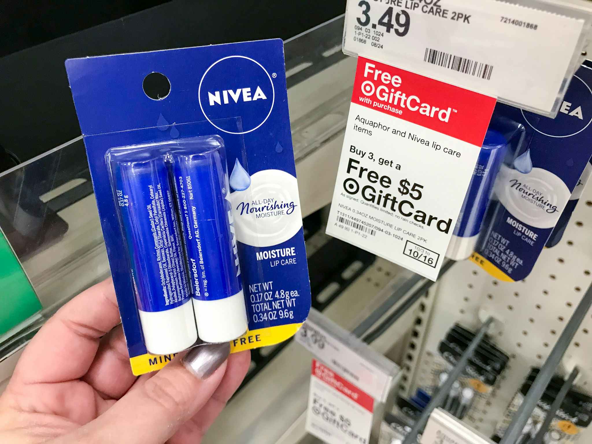 hand holding nivea lip balm 2-pack in front of target gift card tag