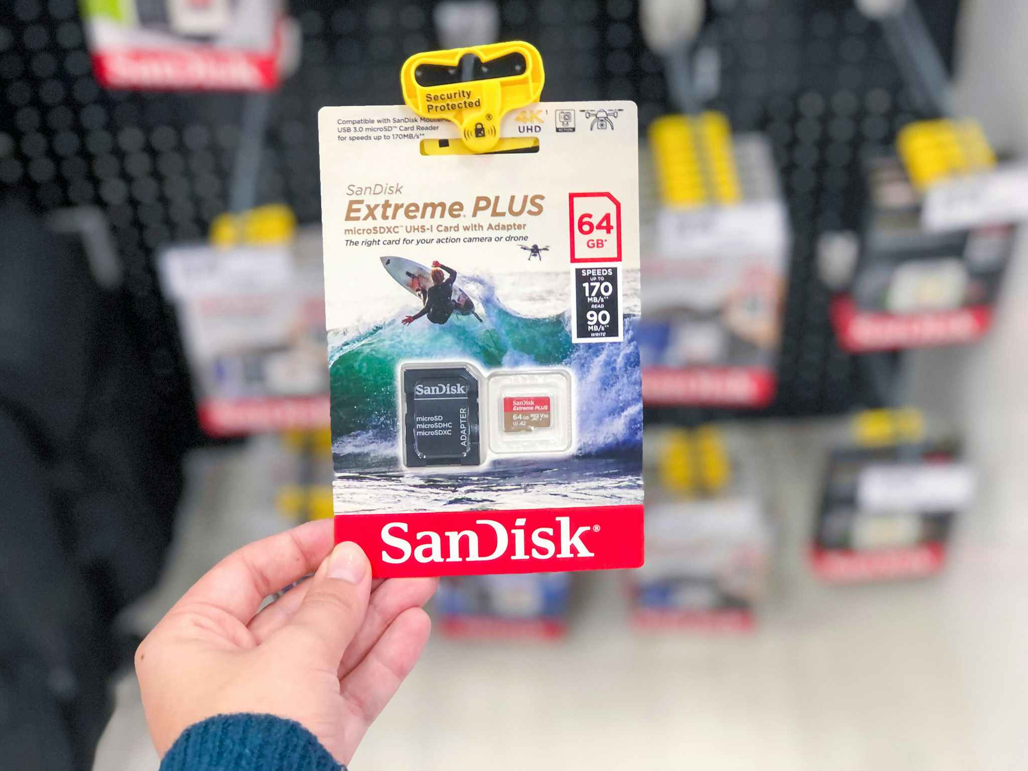 hand holding a sandisk memory card at target
