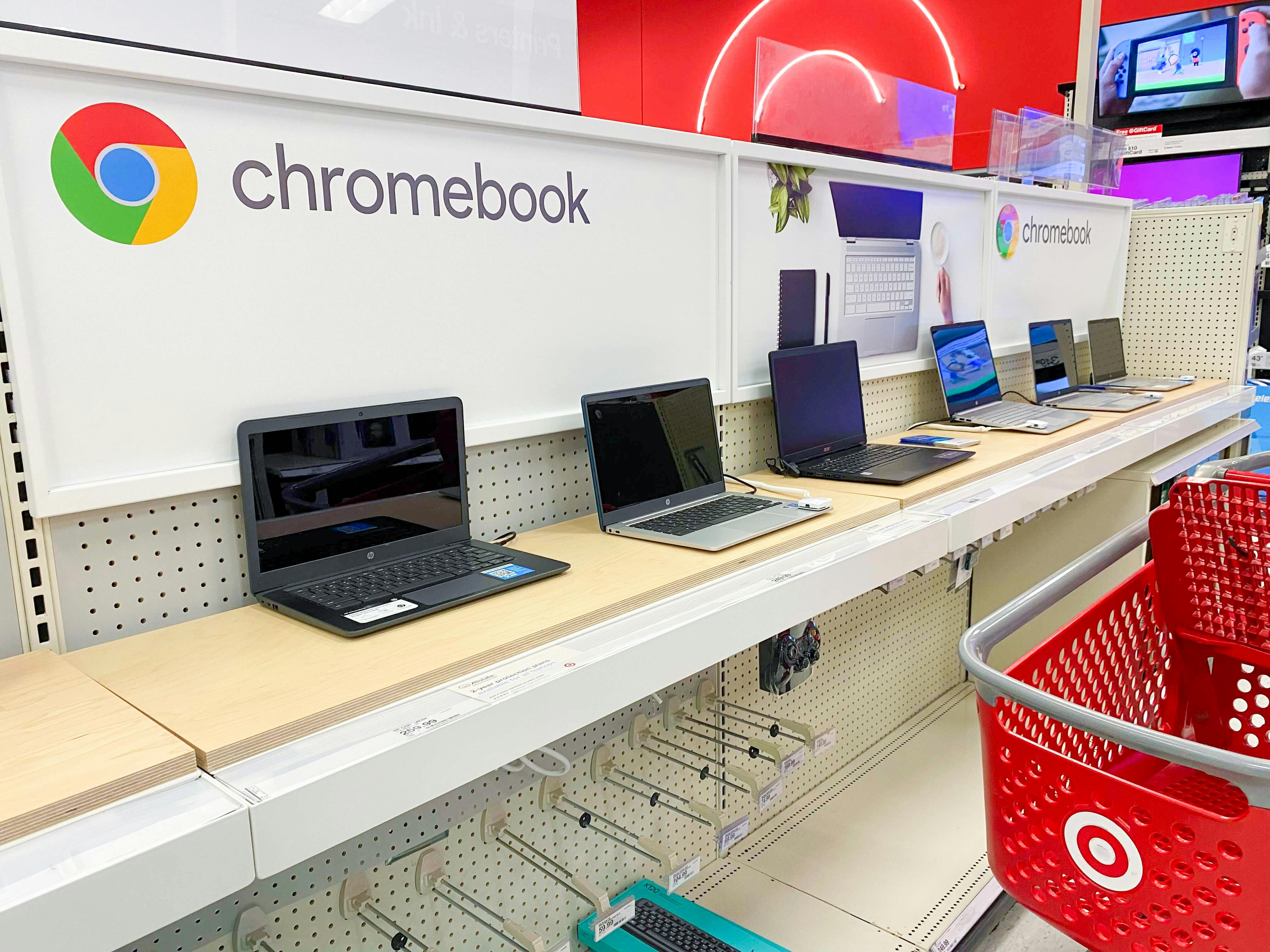 A Target shopping cart parked in front of the Chromebook display in the electronics department in Target.