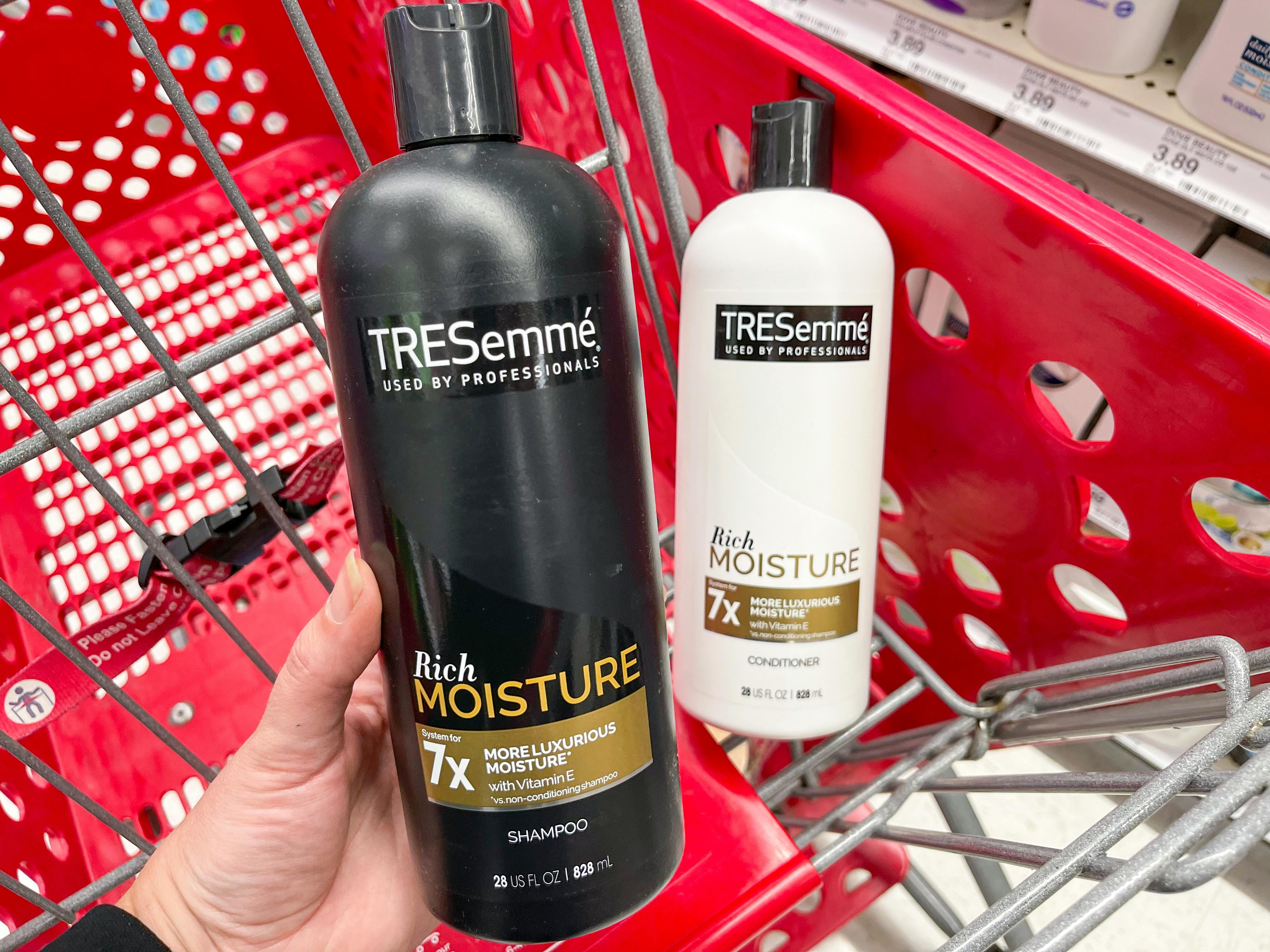 Tresemme shampoo and conditioner in a red Target shopping cart.