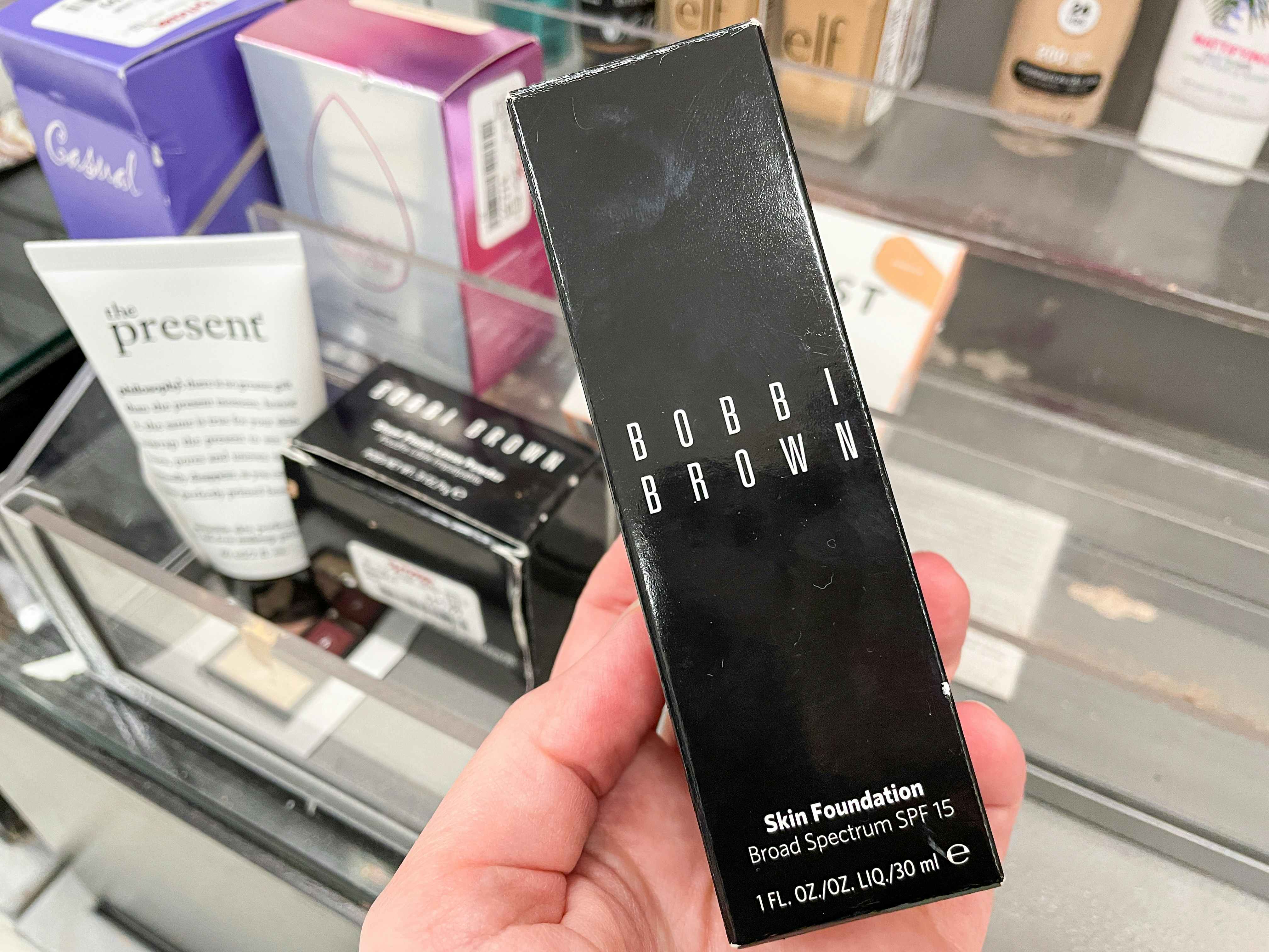 someone holding bobbi brown foundation at tjmaxx
