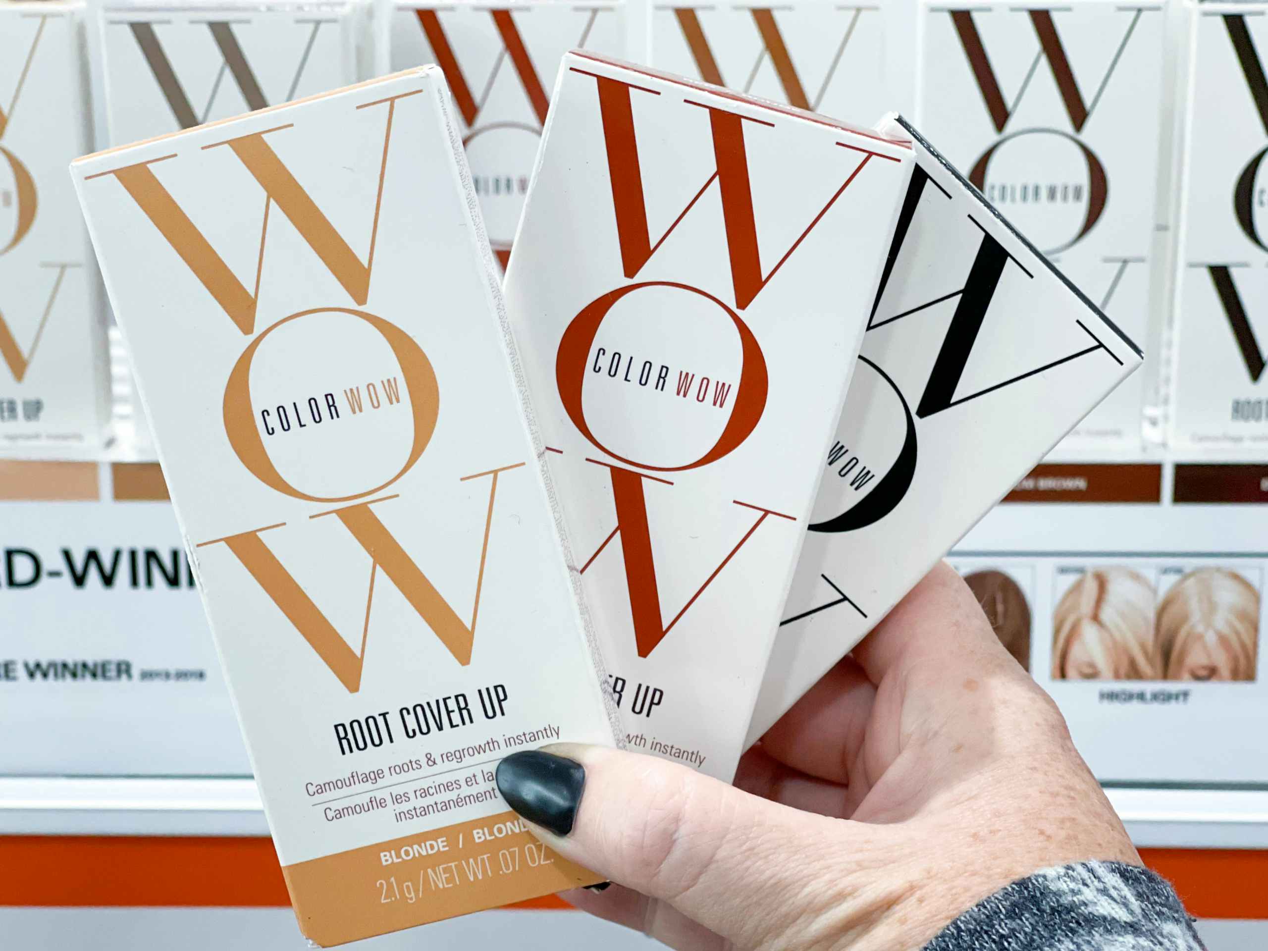 color wow root cover up boxes being held