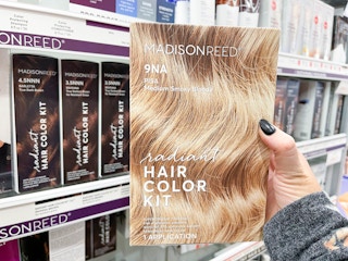 madison reed hair color kit being held in front of shelf