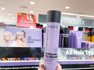 matrix hair shampoo being held in front of shelf