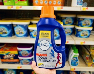 hand holding febreze odor eliminator at walmart