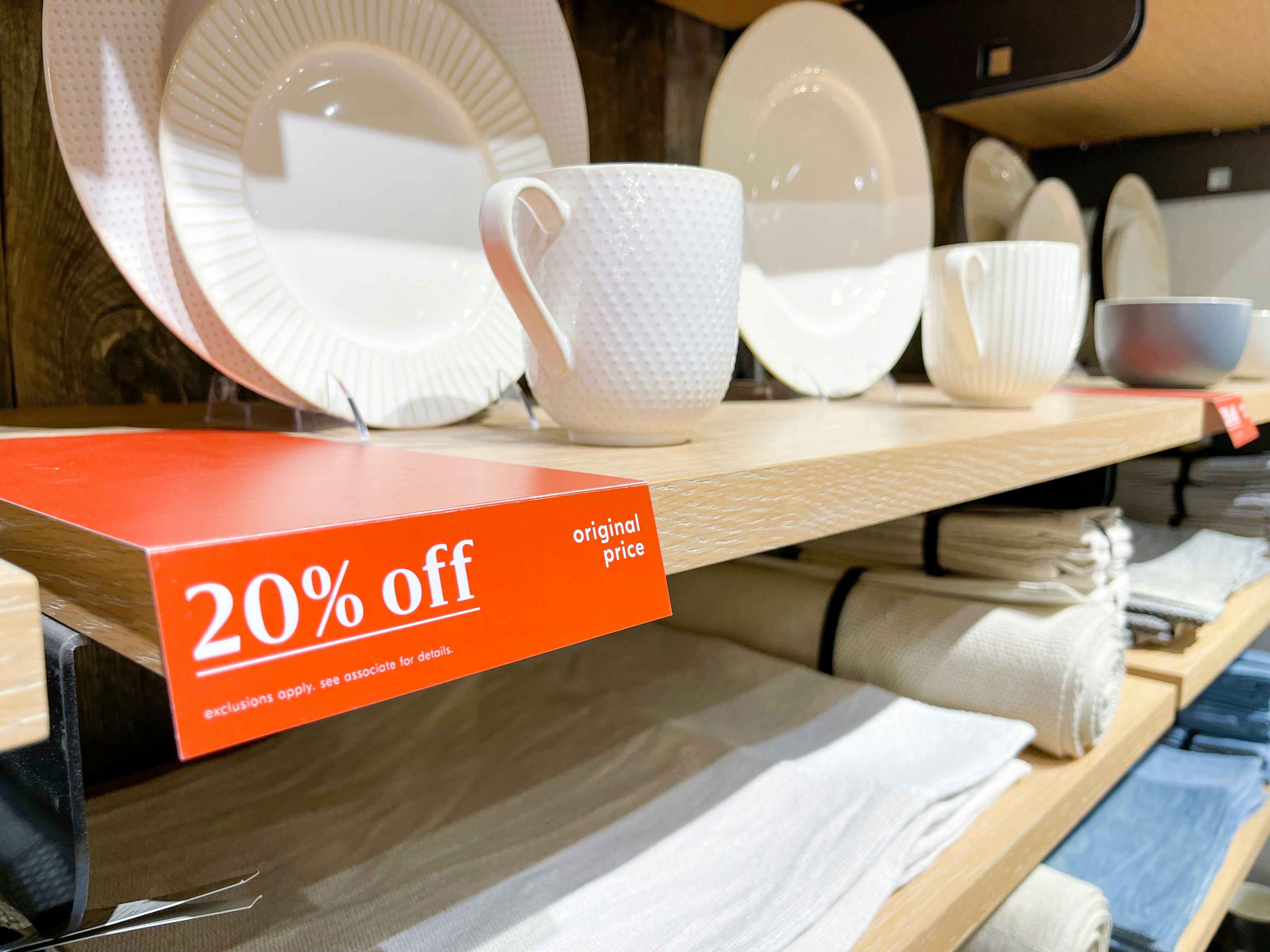 20% off sign next to plates at West Elm