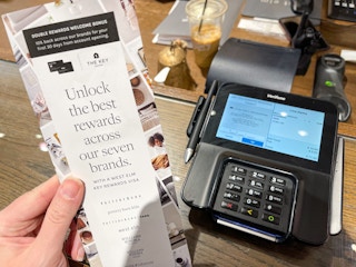 someone holding credit card info next to checkout