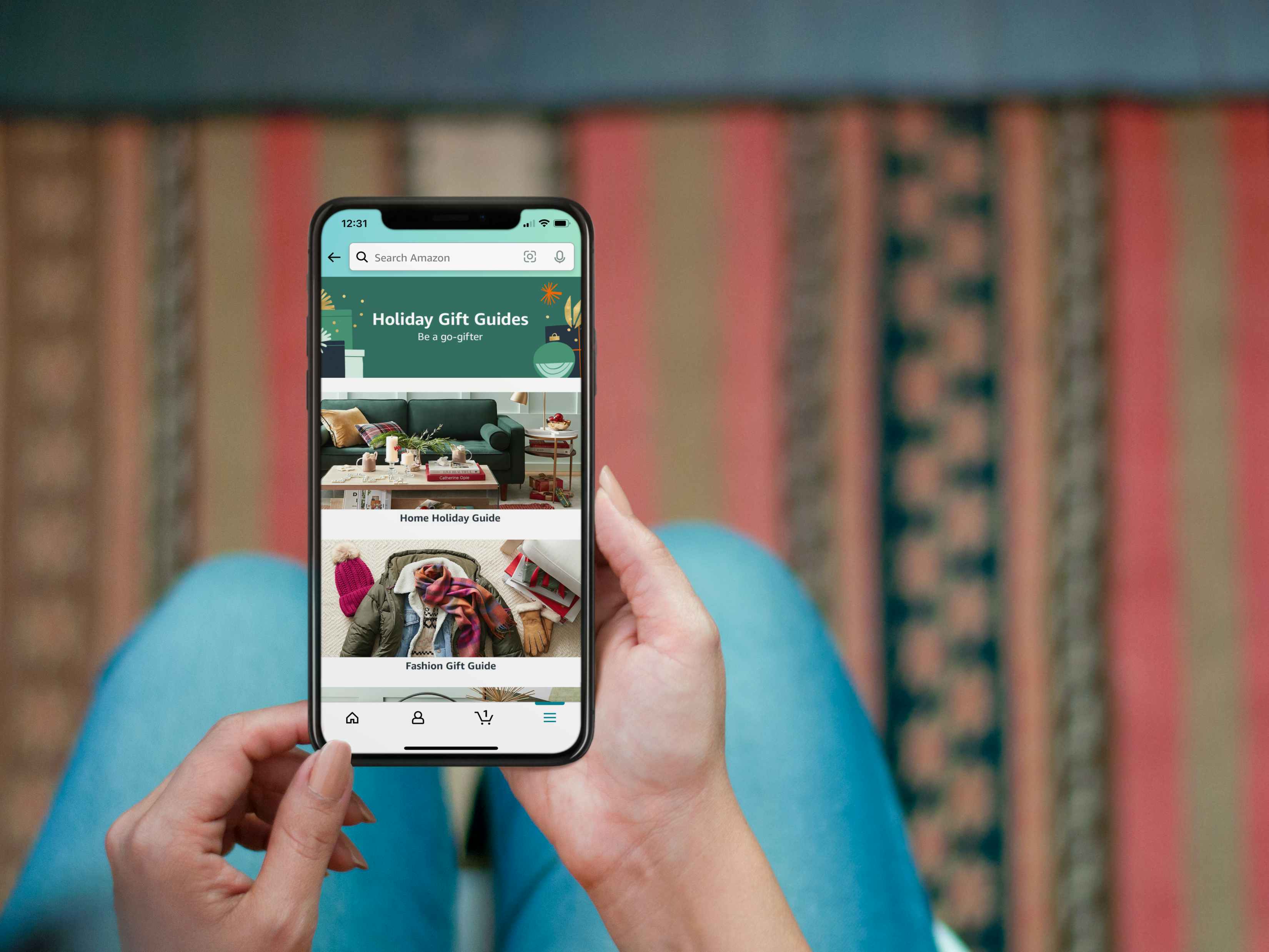 woman shopping for holiday gifts on the amazon mobile app in her living room